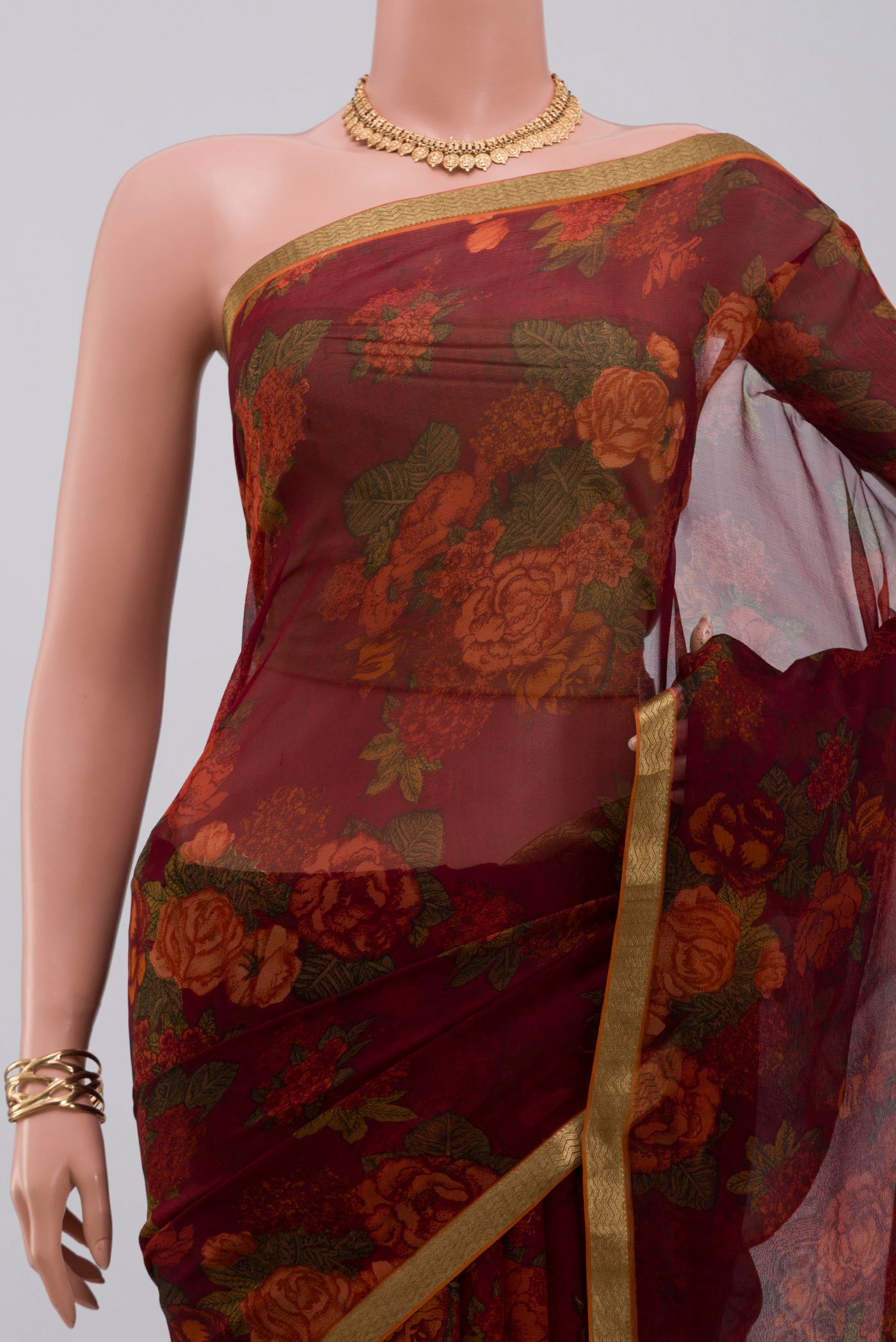 Border image of Maroon Chiffon Saree with Printed design on the body and Zari Border. 