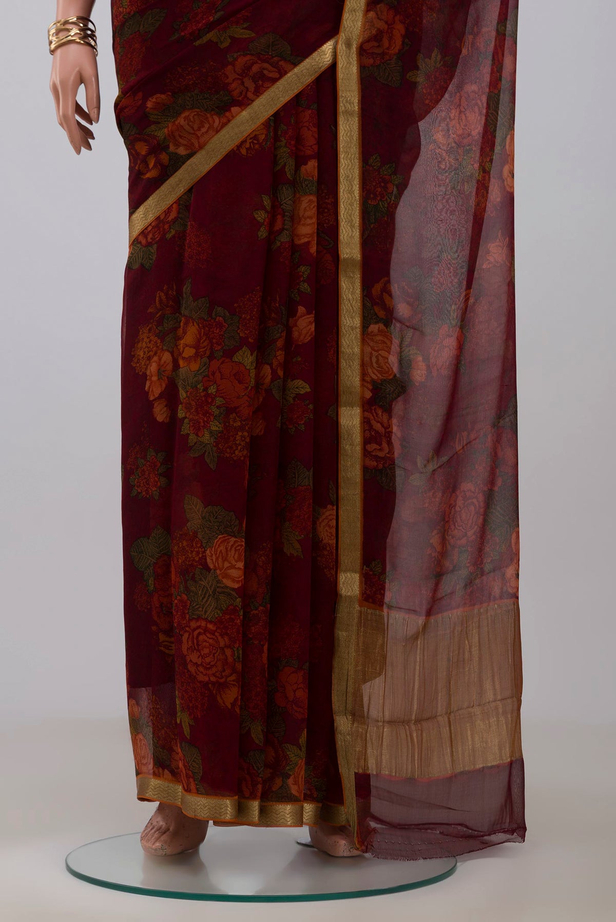 Pleats and pallu of Maroon Chiffon Saree with Printed design on the body and Zari Border. 