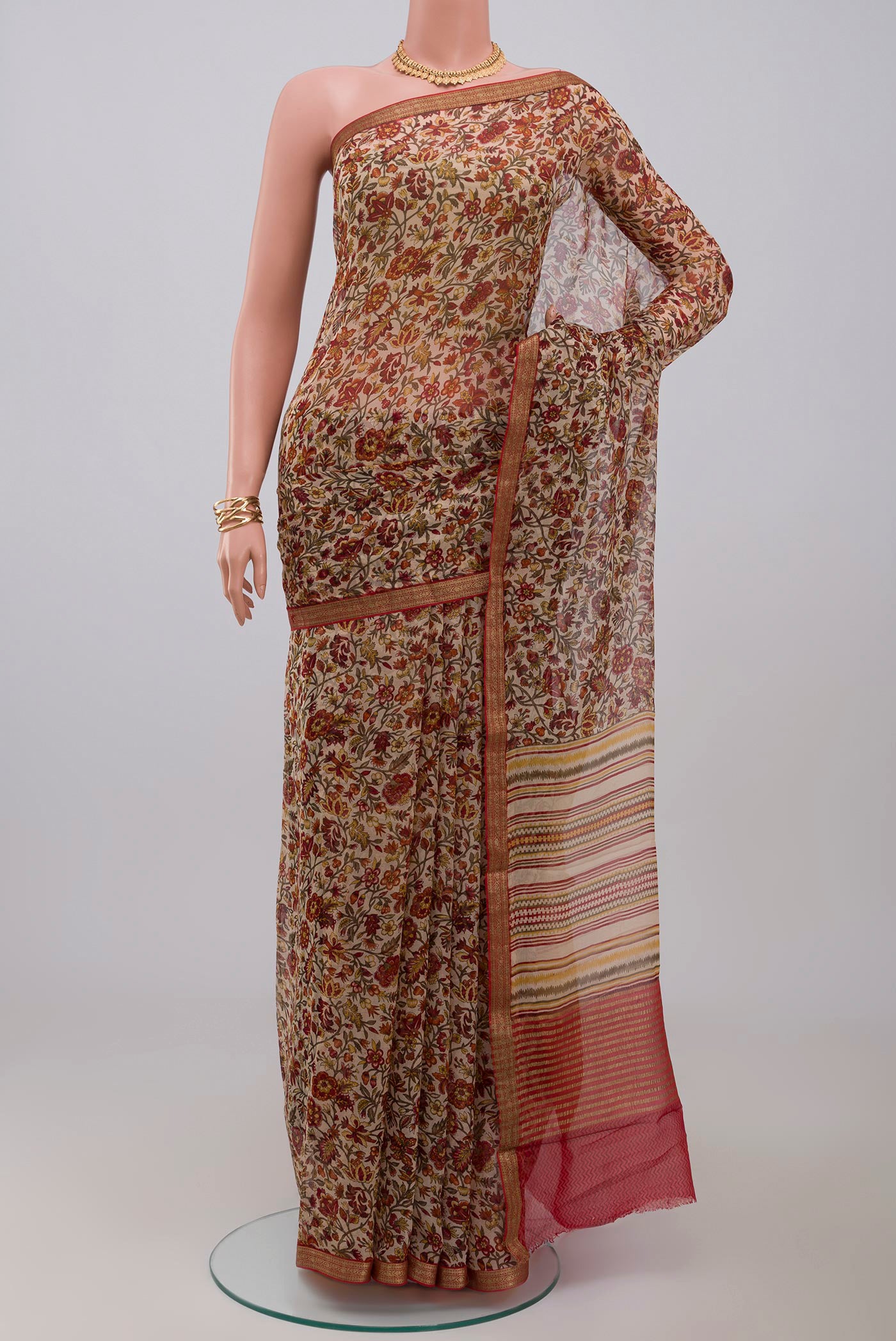 Cream Chiffon Saree with Printed design on the body and Zari Border.  displayed on a mannequin