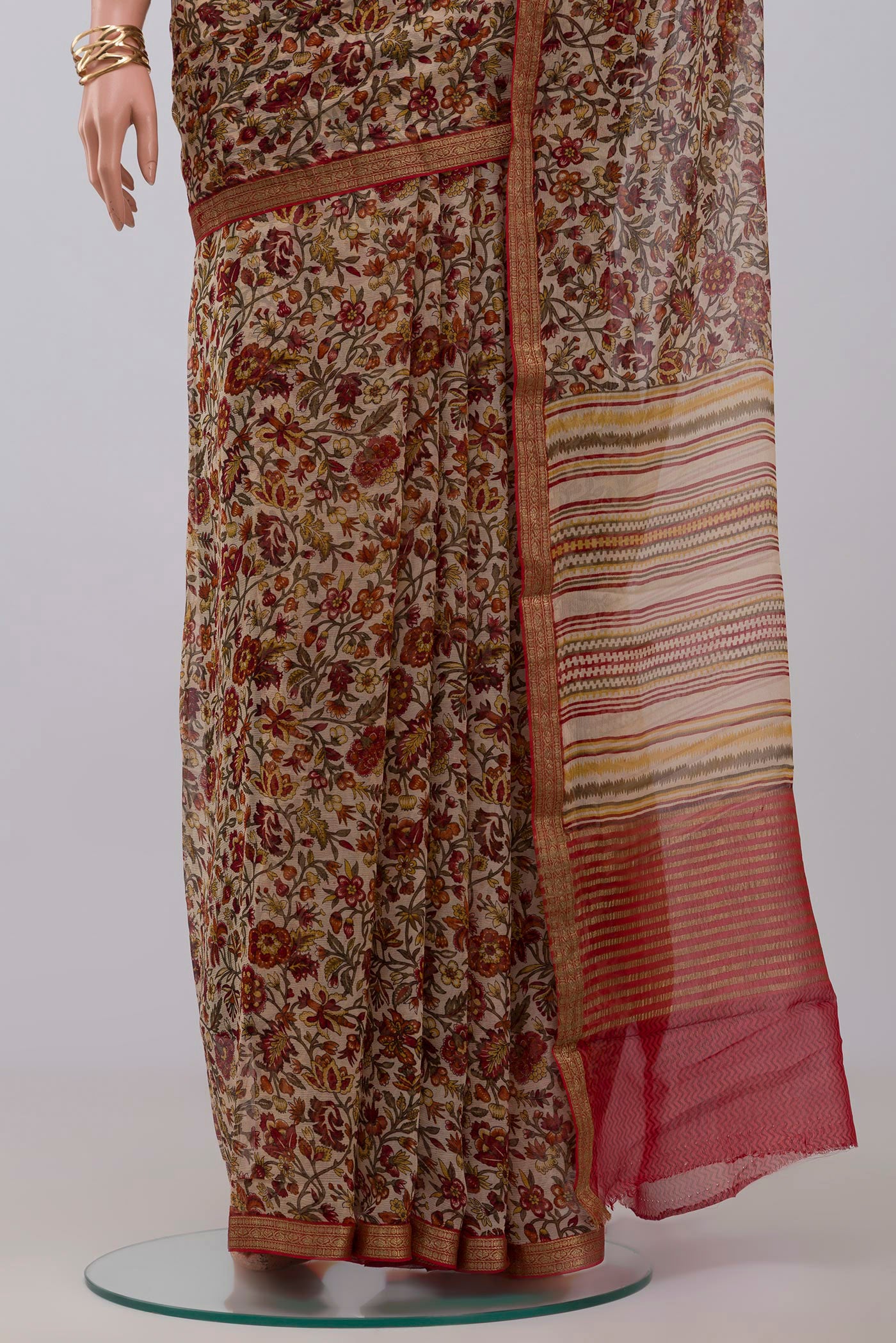 Pleats and pallu of Cream Chiffon Saree with Printed design on the body and Zari Border. 