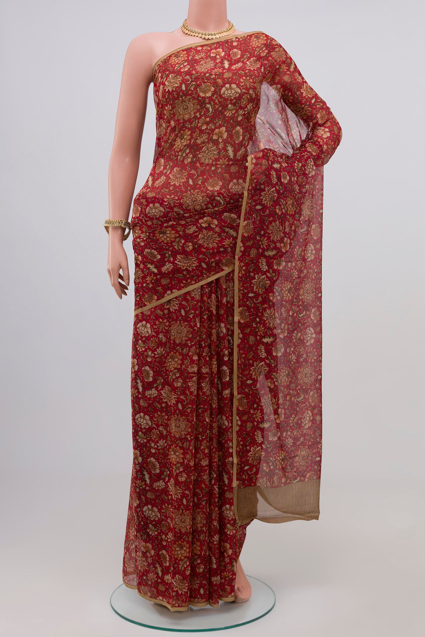 Red Chiffon Saree with Printed design on the body and Plain Border.  displayed on a mannequin