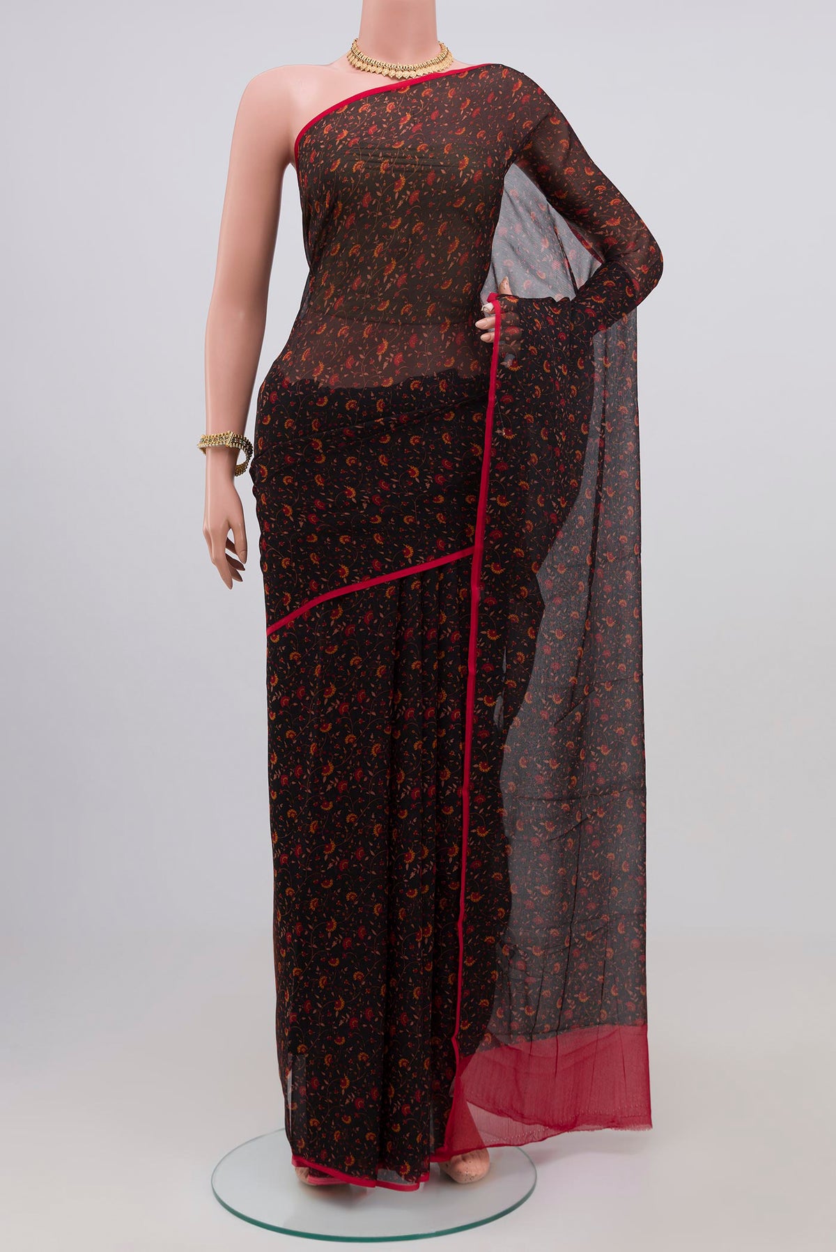 Black Chiffon Saree with Printed design on the body and Plain Border.  displayed on a mannequin