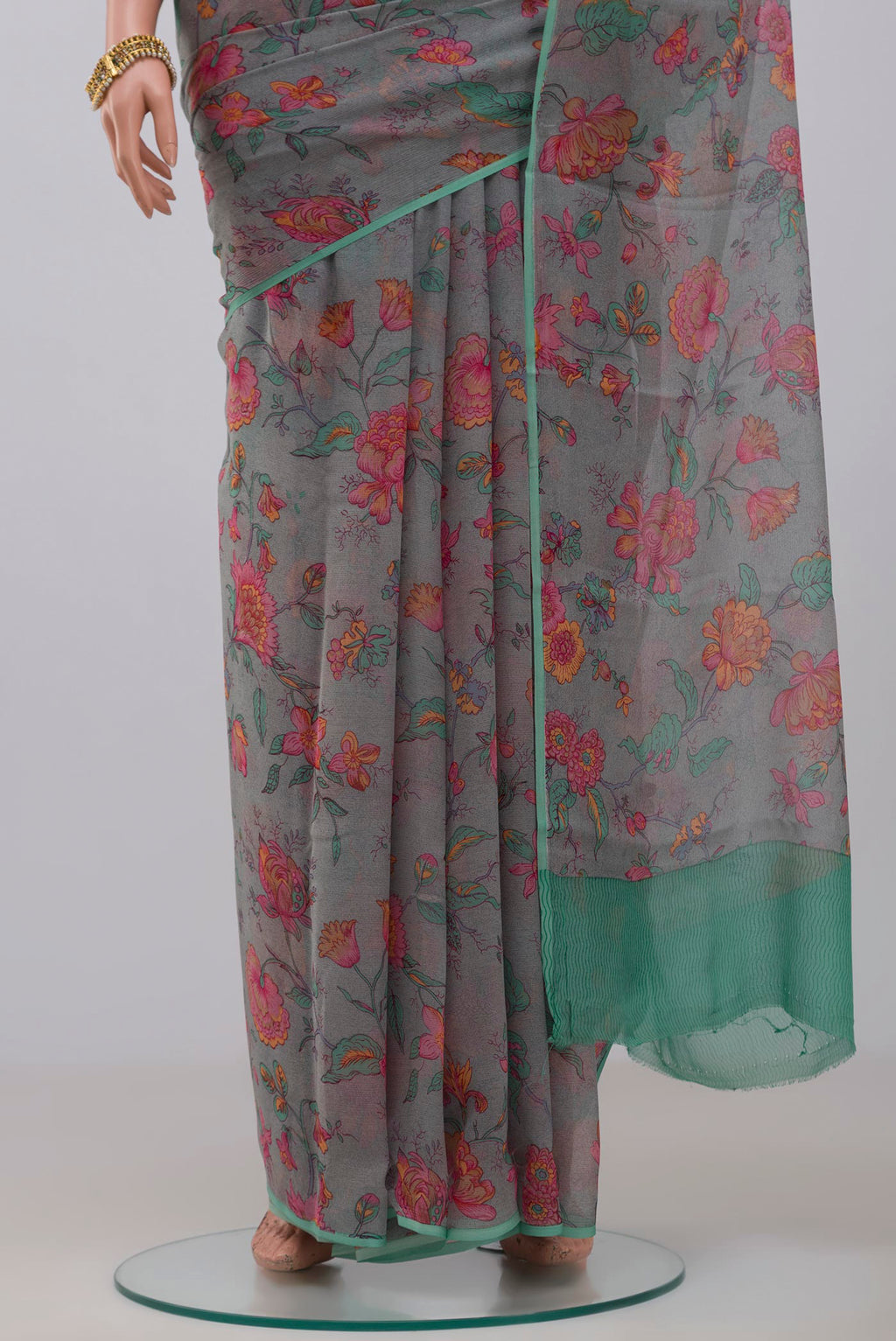 Pleats and pallu of Grey Chiffon Saree with Printed design on the body and Without Border. 