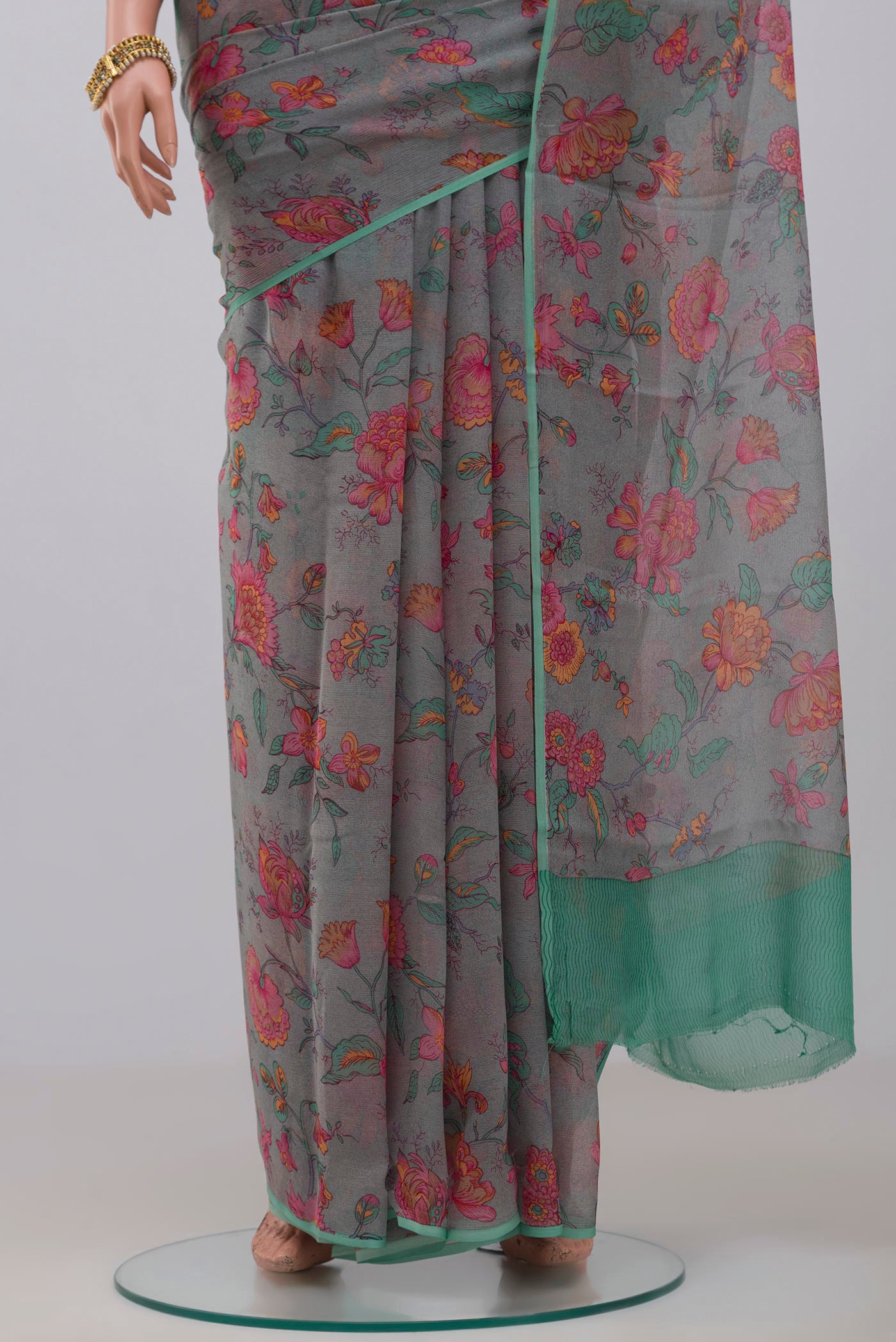 Pleats and pallu of Grey Chiffon Saree with Printed design on the body and Without Border. 