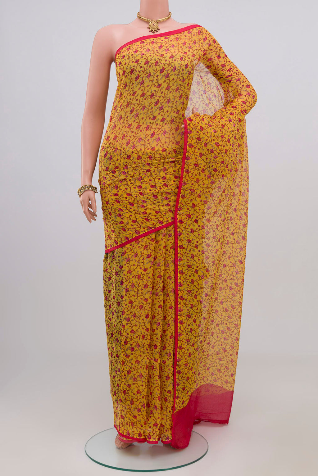 Yellow Chiffon Saree with Printed design on the body and Without Border.  displayed on a mannequin
