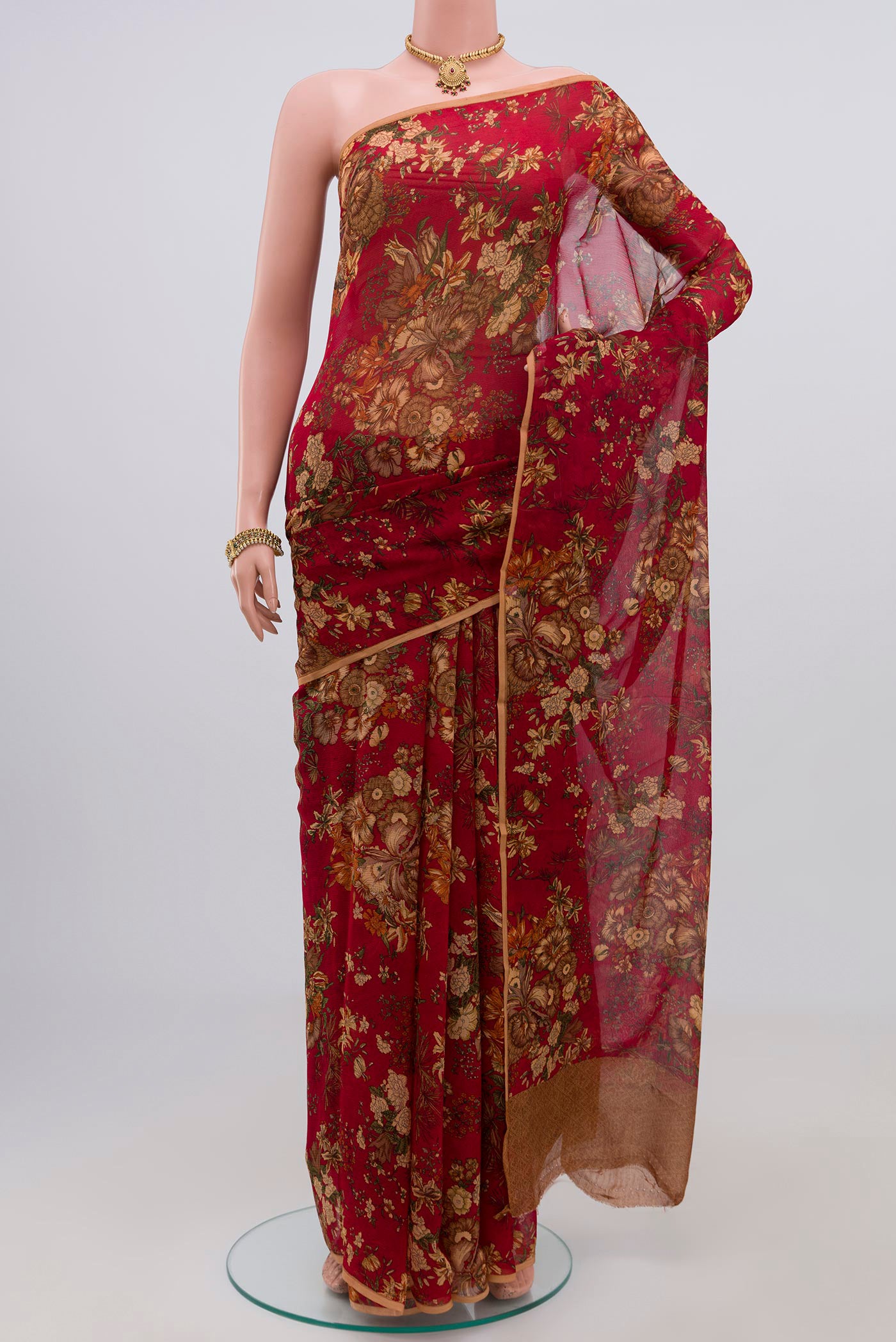 Red Chiffon Saree with Printed design on the body and Without Border.  displayed on a mannequin