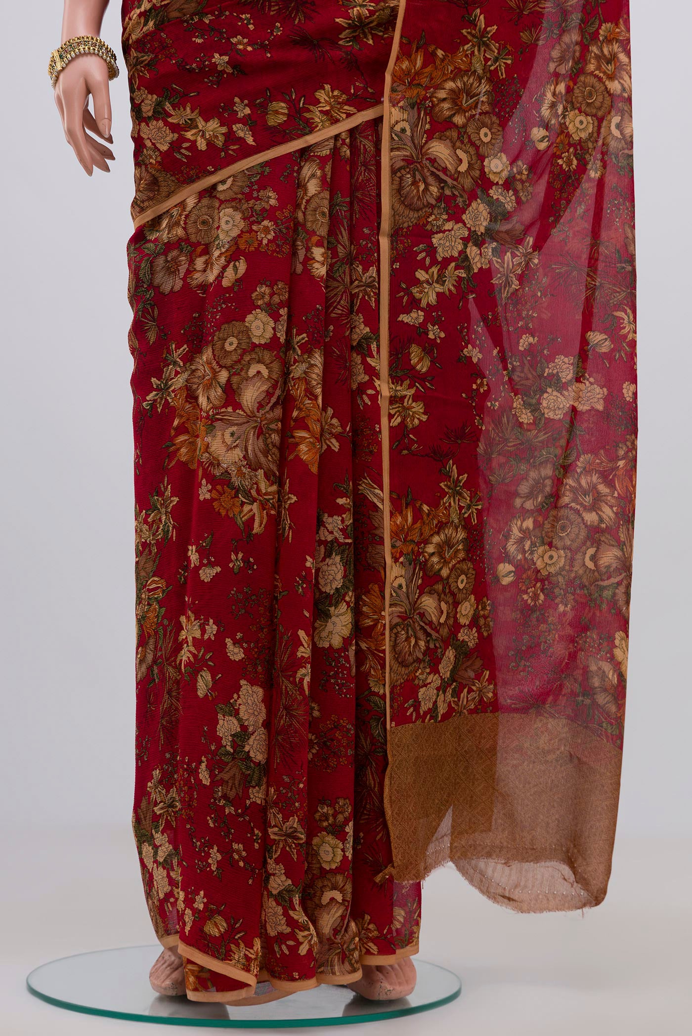 Pleats and pallu of Red Chiffon Saree with Printed design on the body and Without Border. 