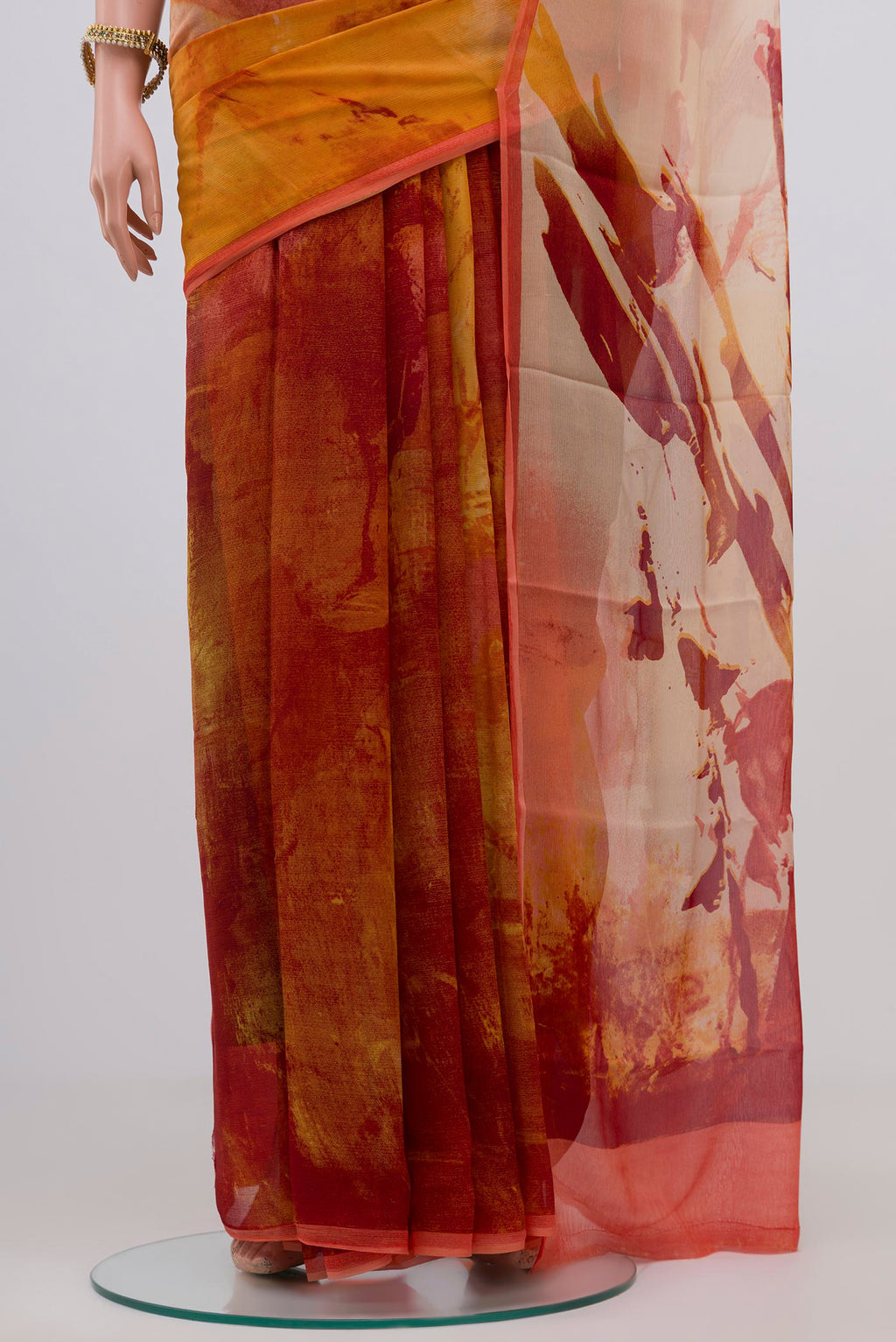 Pleats and pallu of Yellow Chiffon Saree with Printed design on the body and Zari Border. 
