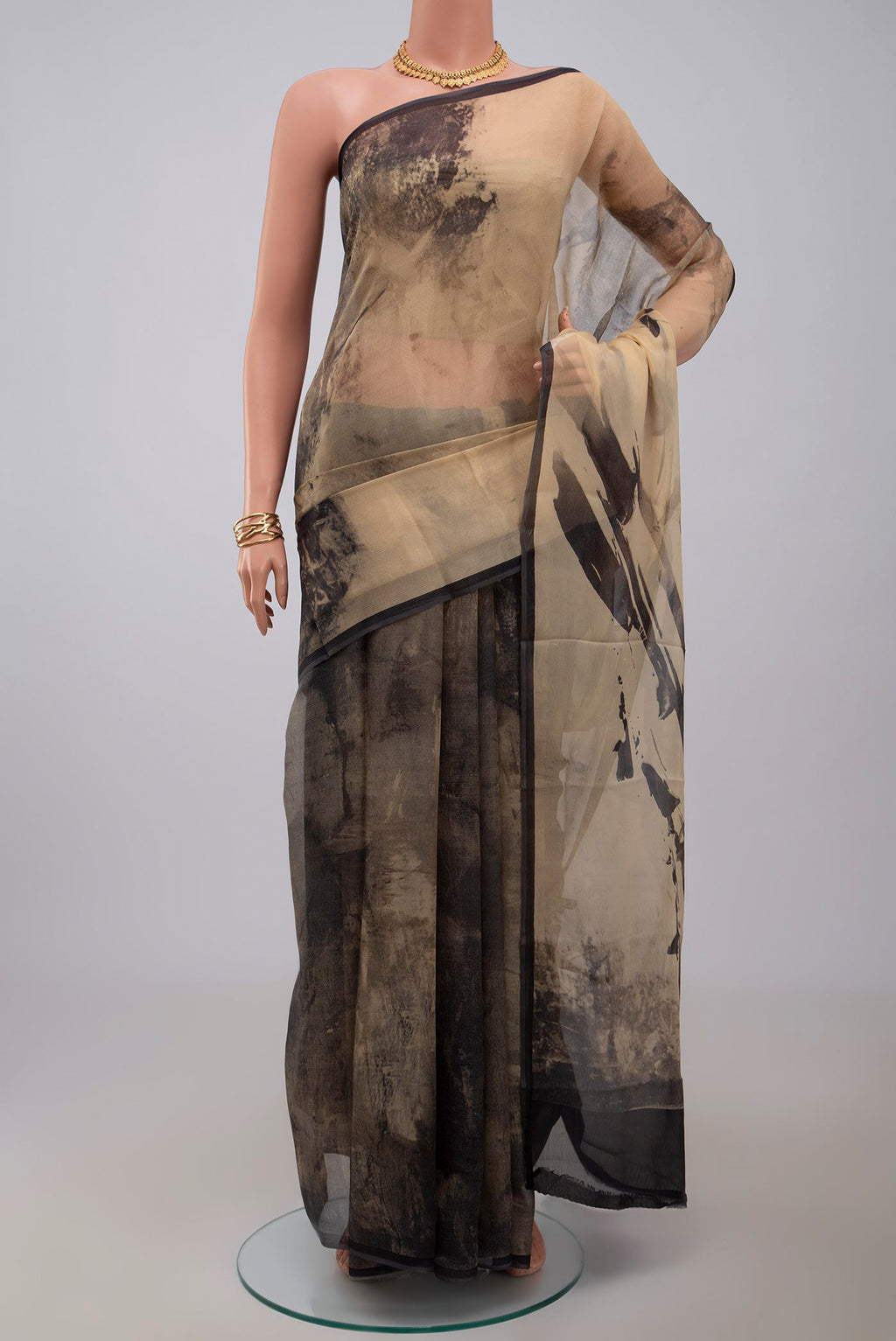 Beige Chiffon Saree with Printed design on the body and Without Border.  displayed on a mannequin