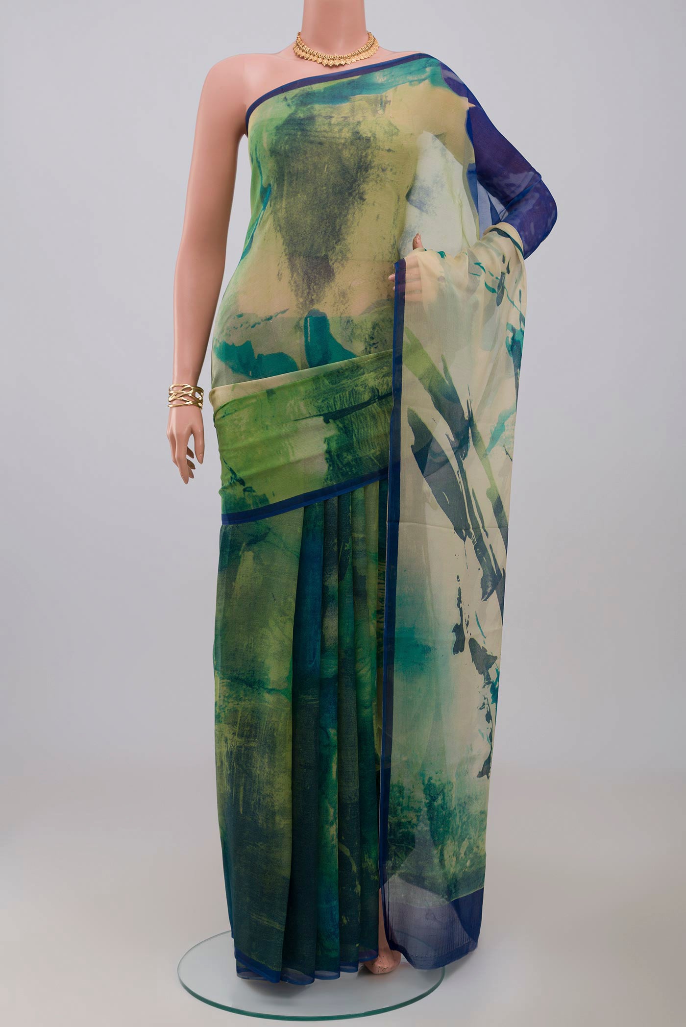 Green Chiffon Saree with Printed design on the body and Without Border.  displayed on a mannequin