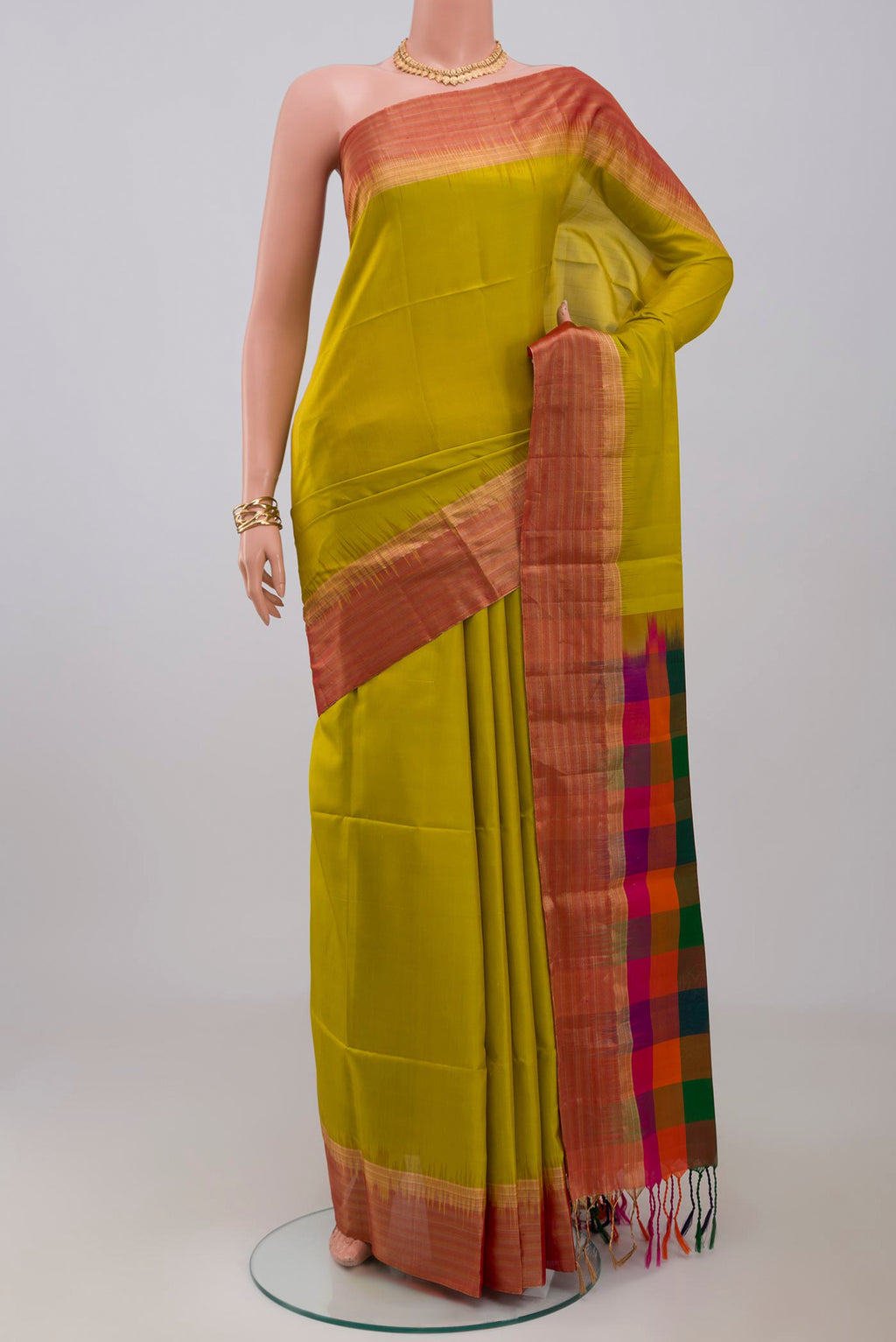 Green Soft Silk Saree with Plain Body and Zari Border.  displayed on a mannequin