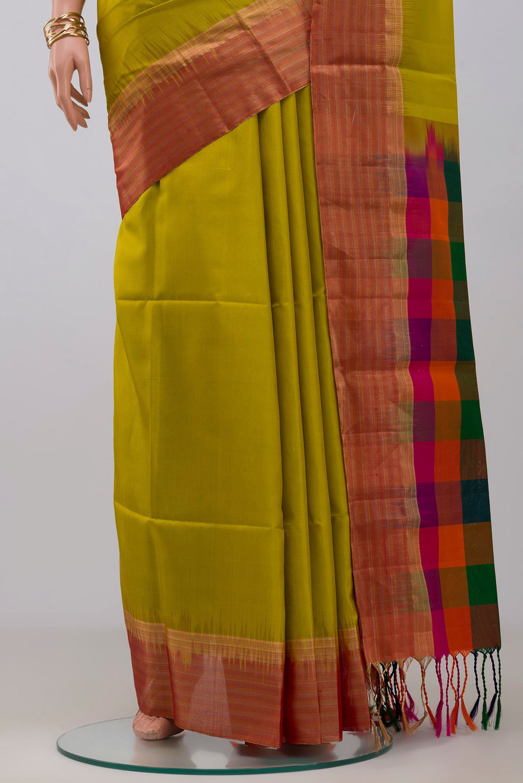 Pleats and pallu of Green Soft Silk Saree with Plain Body and Zari Border. 