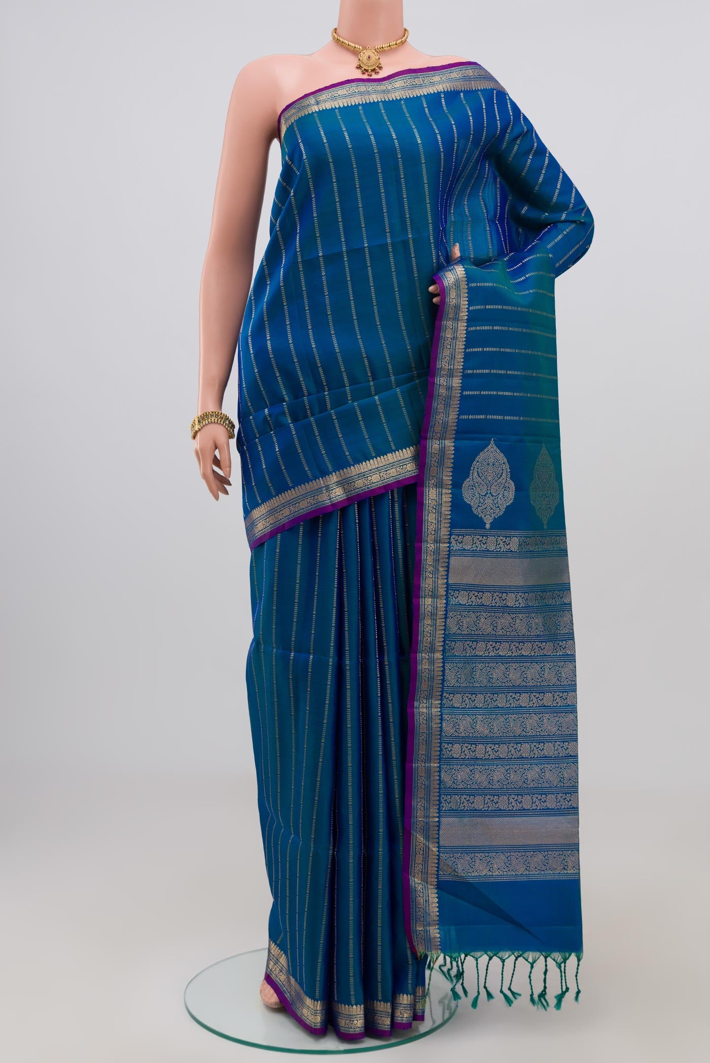 Blue Soft Silk Saree with Stripes on the body and Zari Border.  displayed on a mannequin