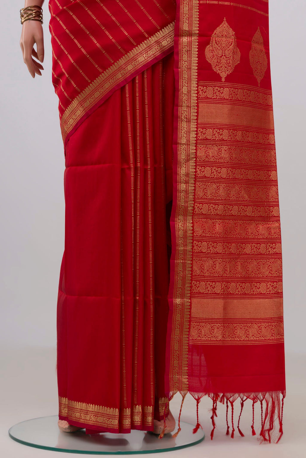 Pleats and pallu of Pure Silk Red Soft Saree with Stripes on the body and Zari Border. 