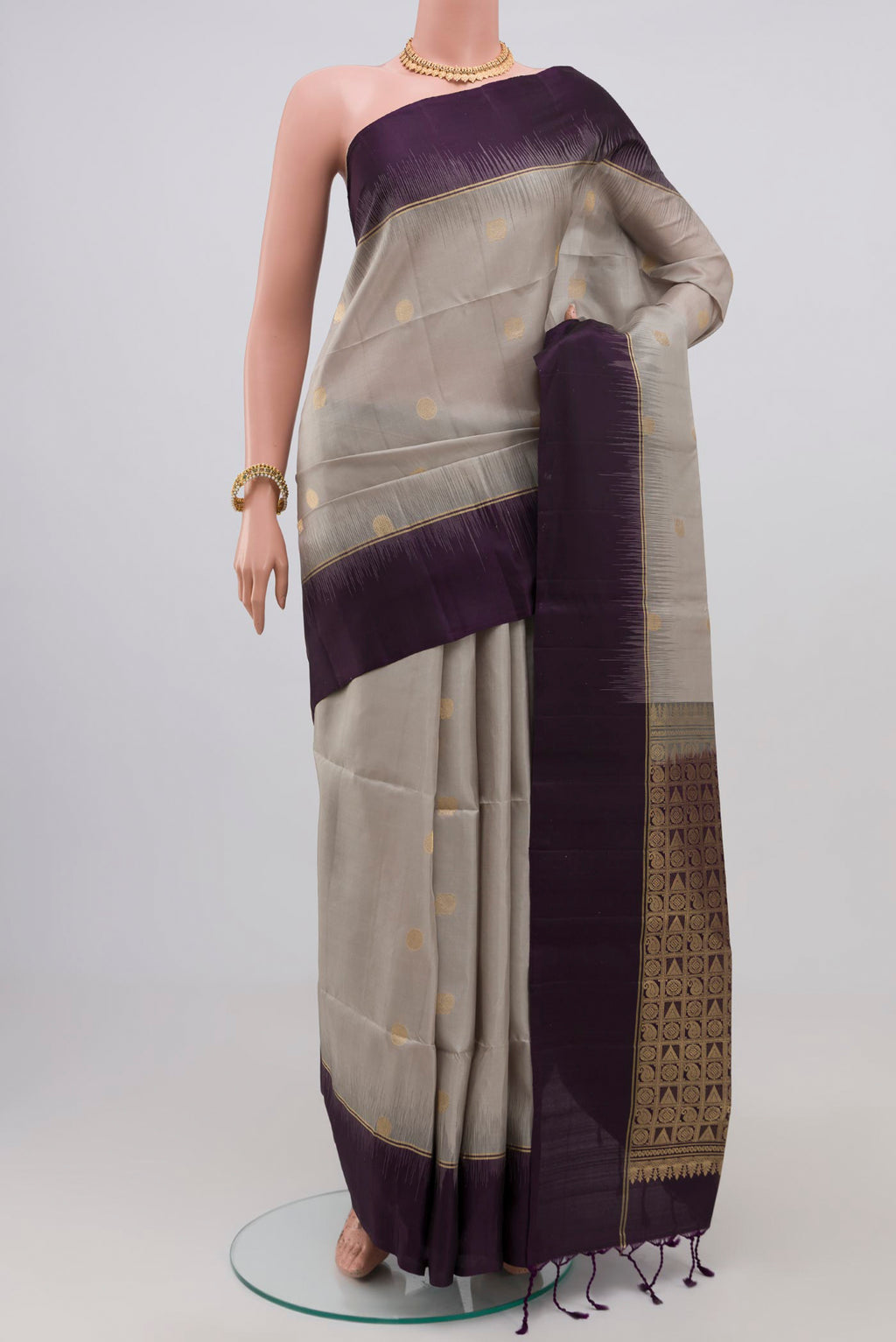 Grey Soft Silk Saree with Zari Butta on the body and Plain Border.  displayed on a mannequin