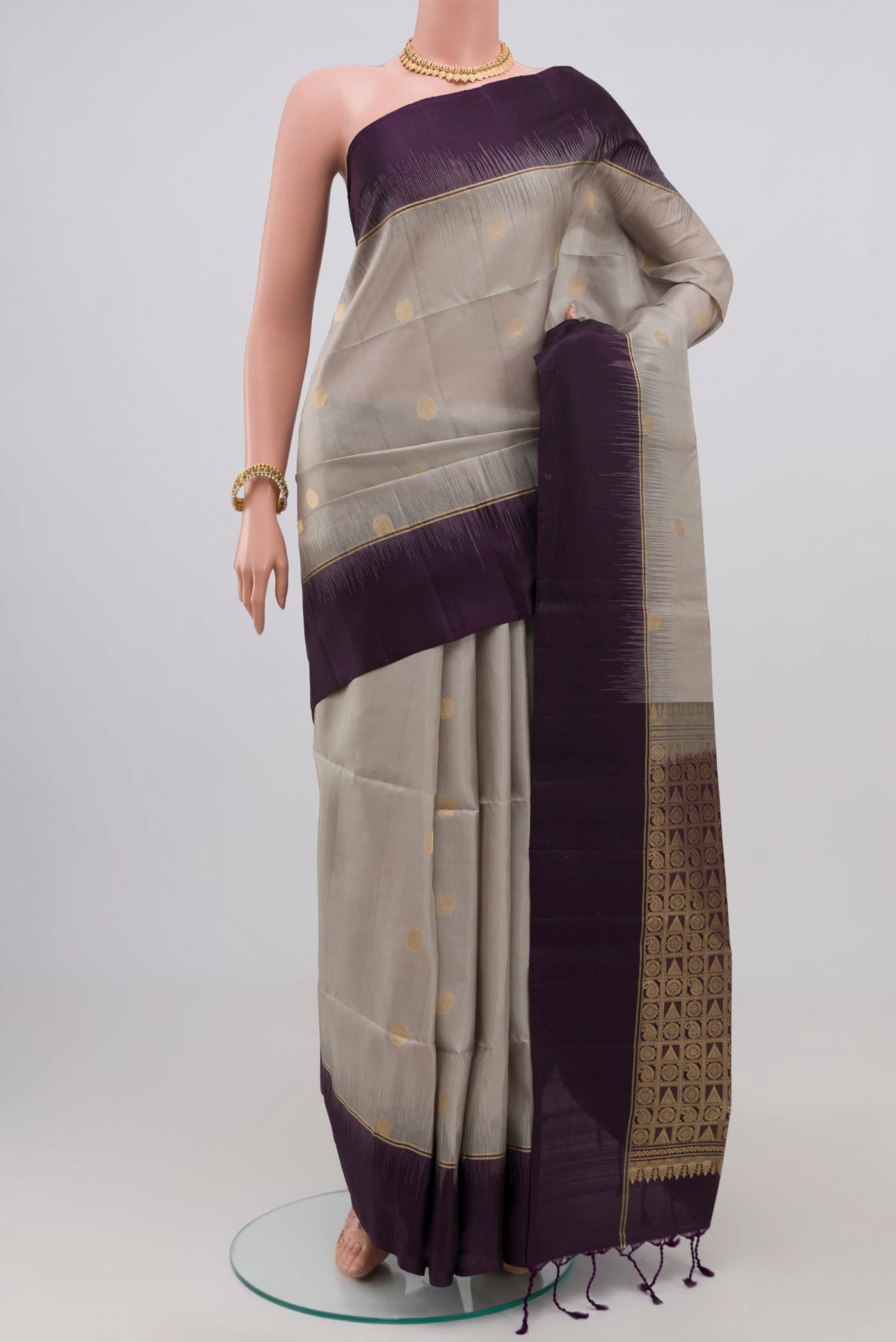 Grey Soft Silk Saree with Zari Butta on the body and Plain Border.  displayed on a mannequin