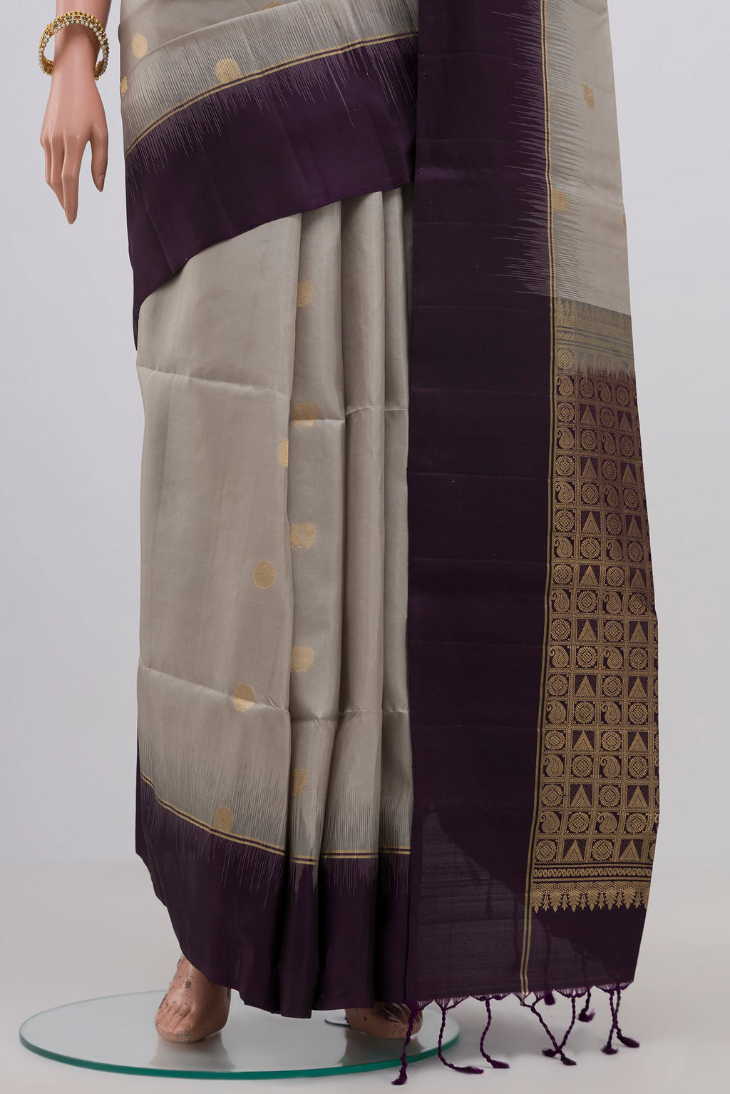 Pleats and pallu of Grey Soft Silk Saree with Zari Butta on the body and Plain Border. 