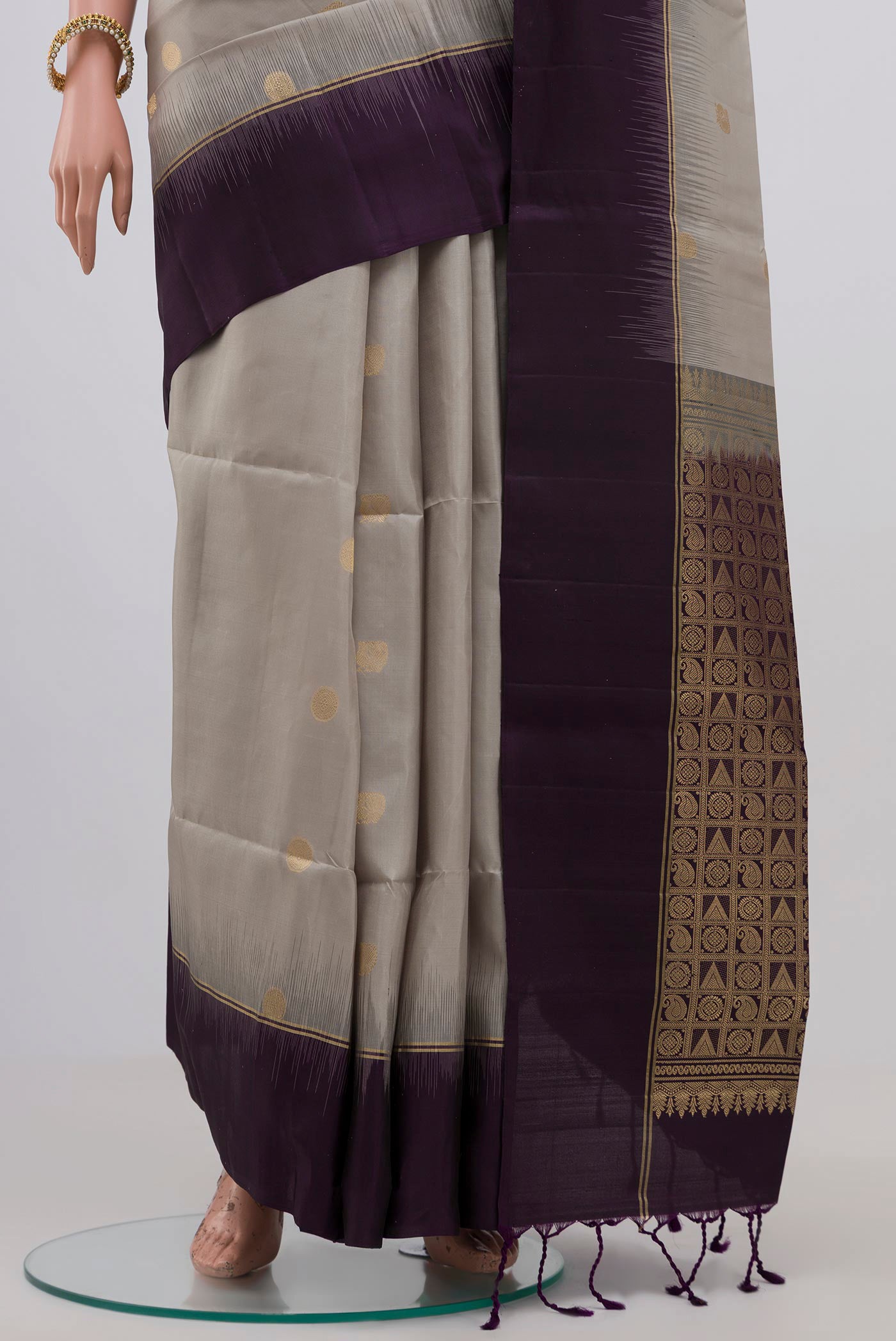 Pleats and pallu of Grey Soft Silk Saree with Zari Butta on the body and Plain Border. 