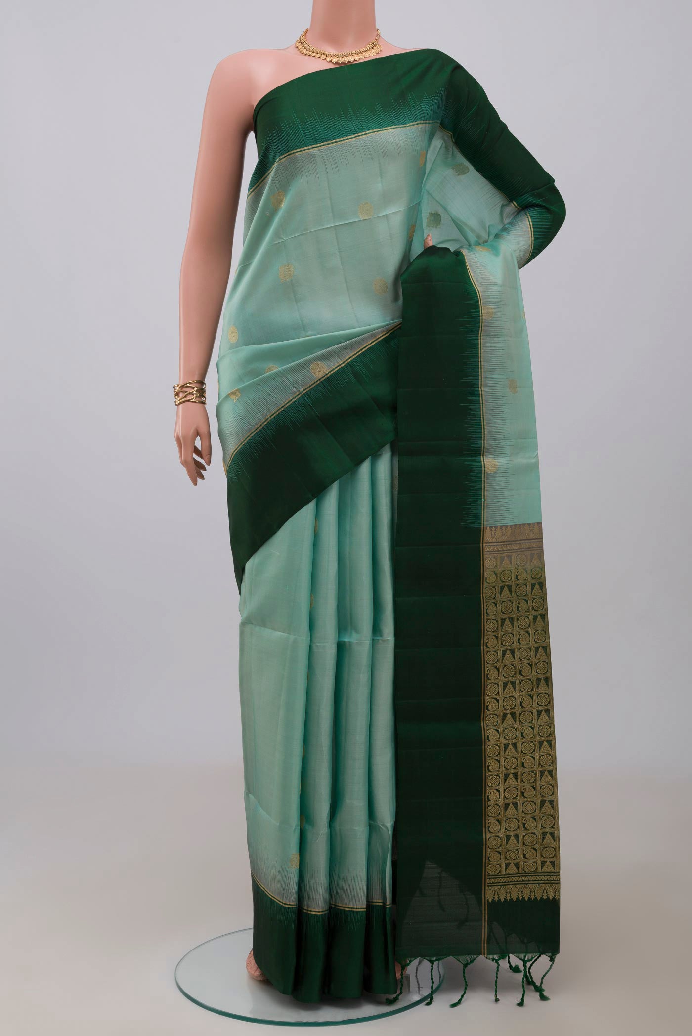 Light Blue Soft Silk Saree with Zari Butta on the body and Plain Border.  displayed on a mannequin