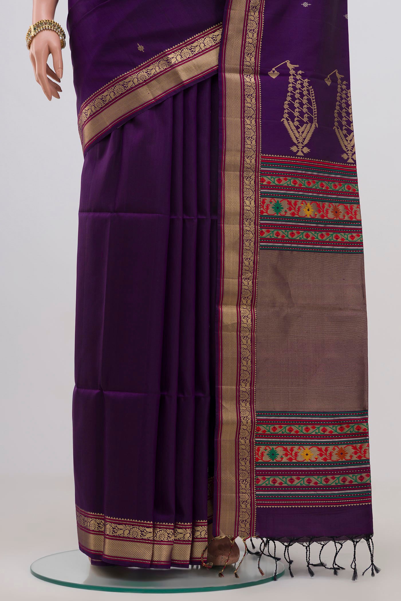 Pleats and pallu of Purple Soft Silk Saree with Zari Butta on the body and Zari Border. 