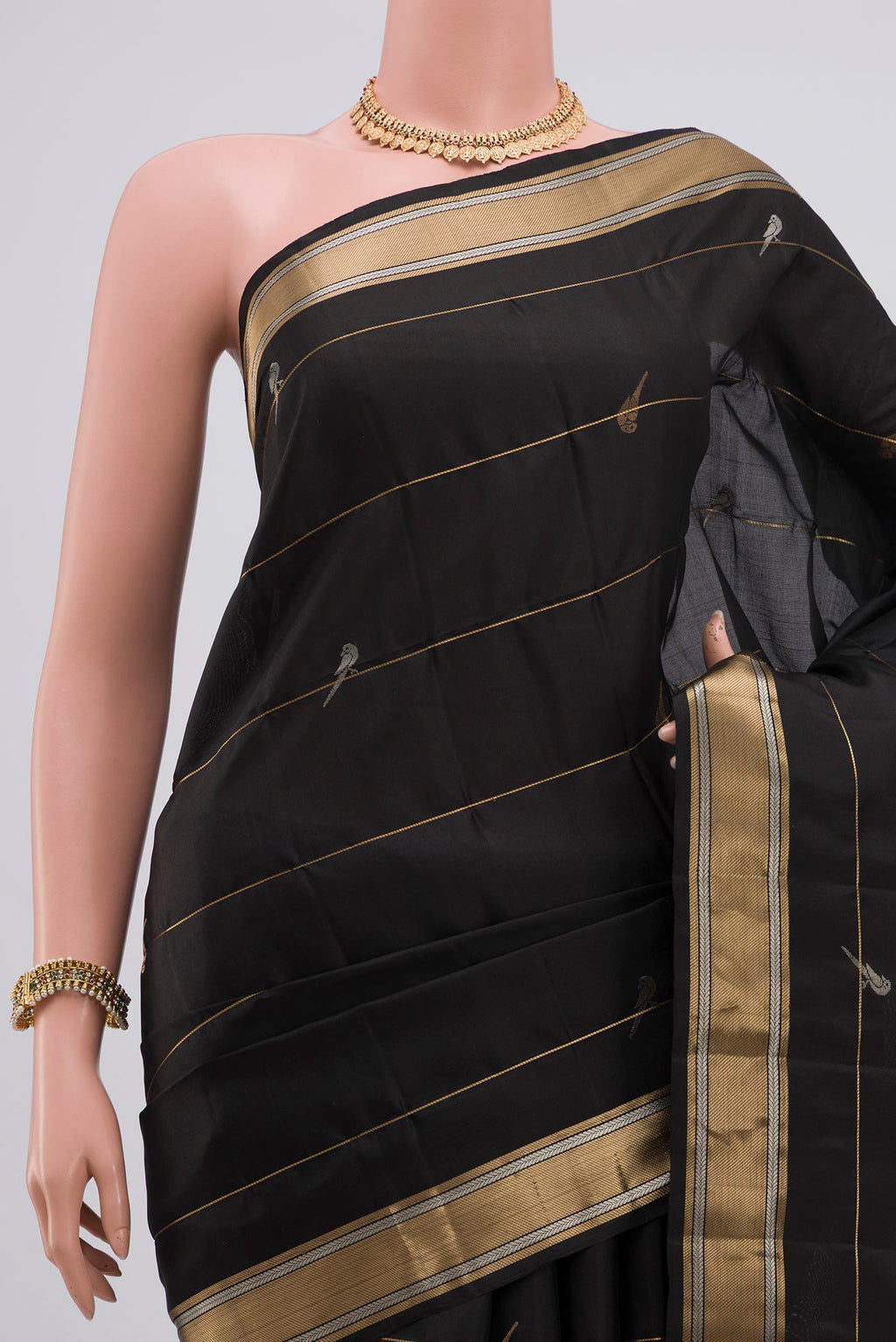 Border image of Black Soft Silk Saree with Zari Butta on the body and Zari Border. 