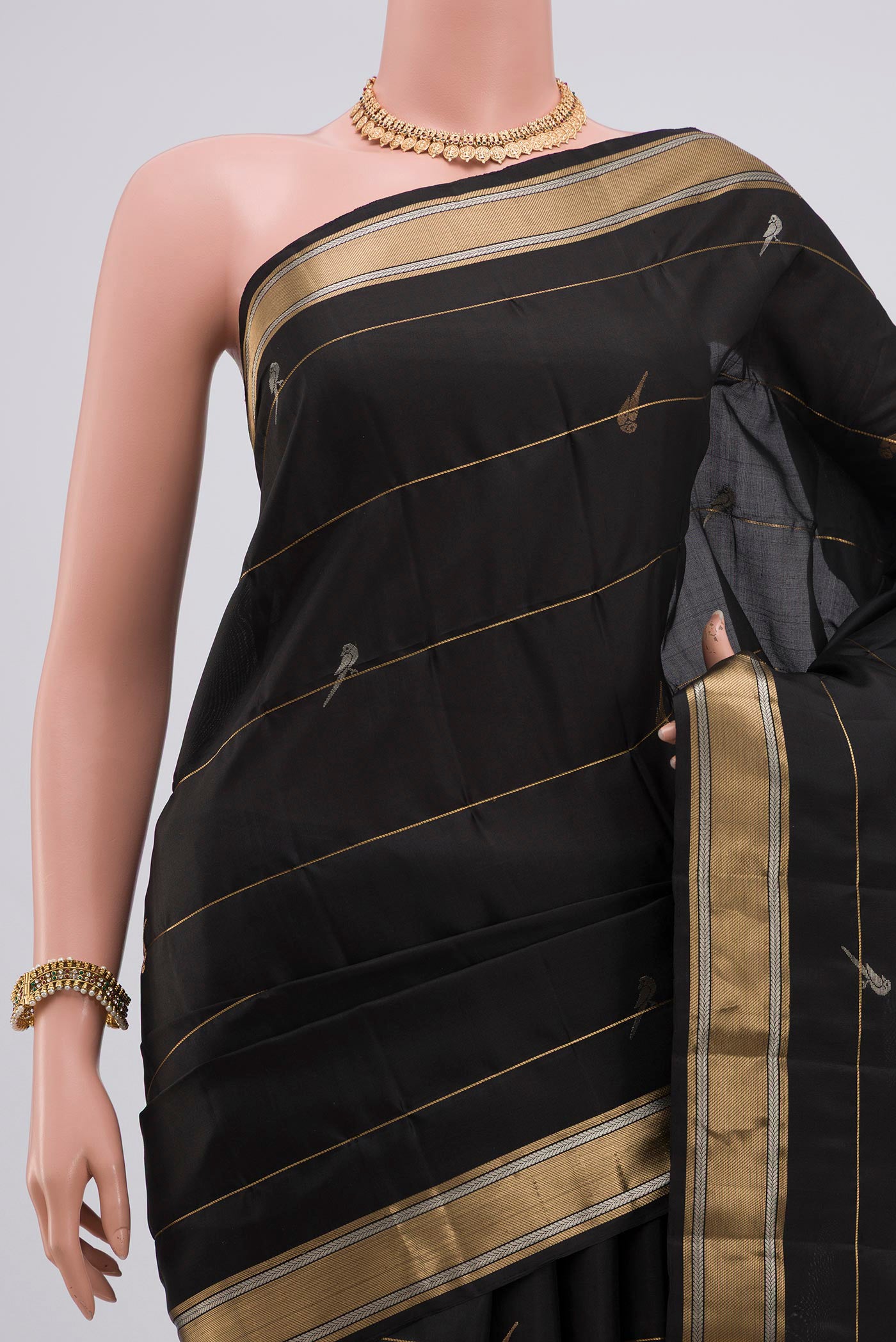 Border image of Black Soft Silk Saree with Zari Butta on the body and Zari Border. 