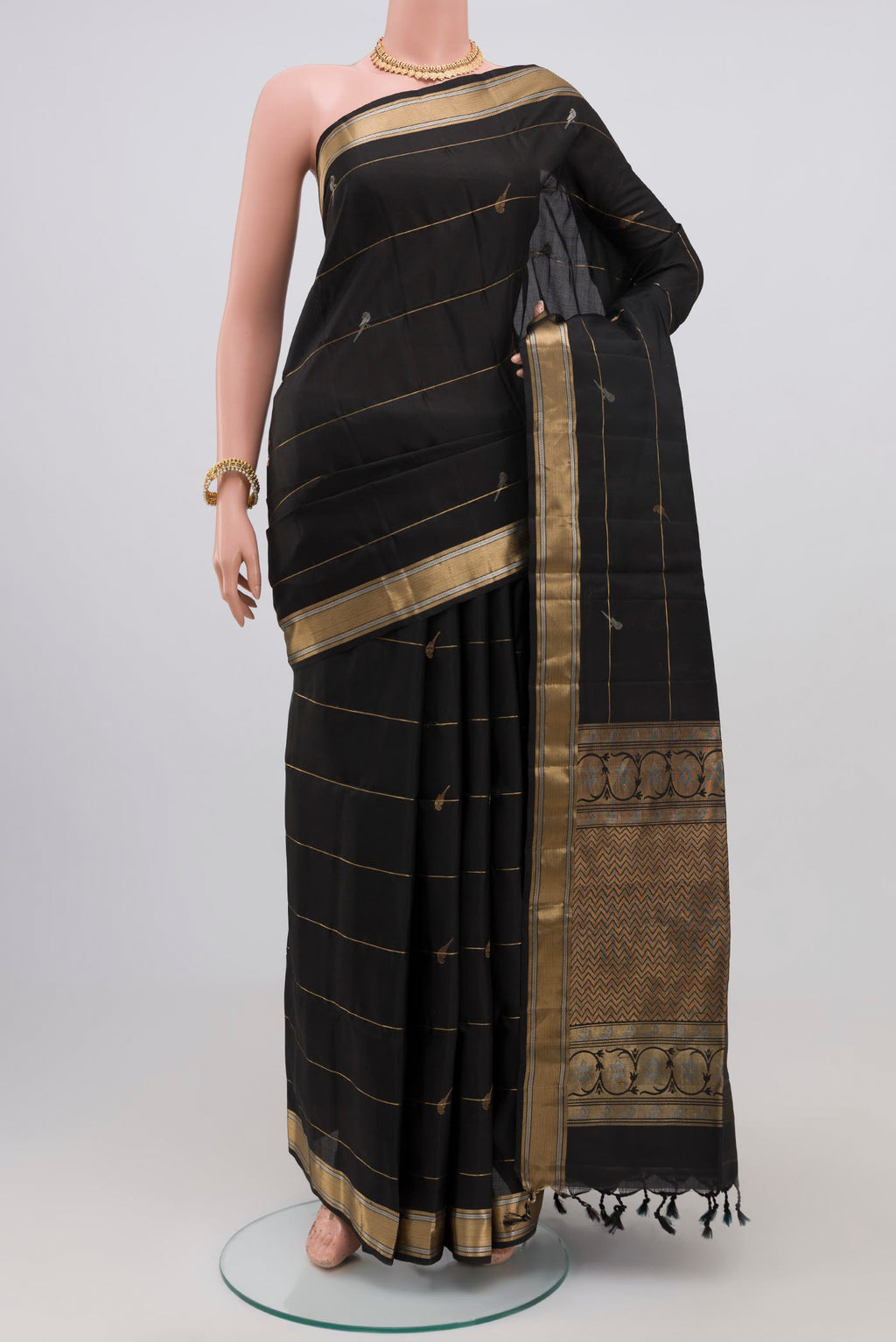 Black Soft Silk Saree with Zari Butta on the body and Zari Border.  displayed on a mannequin