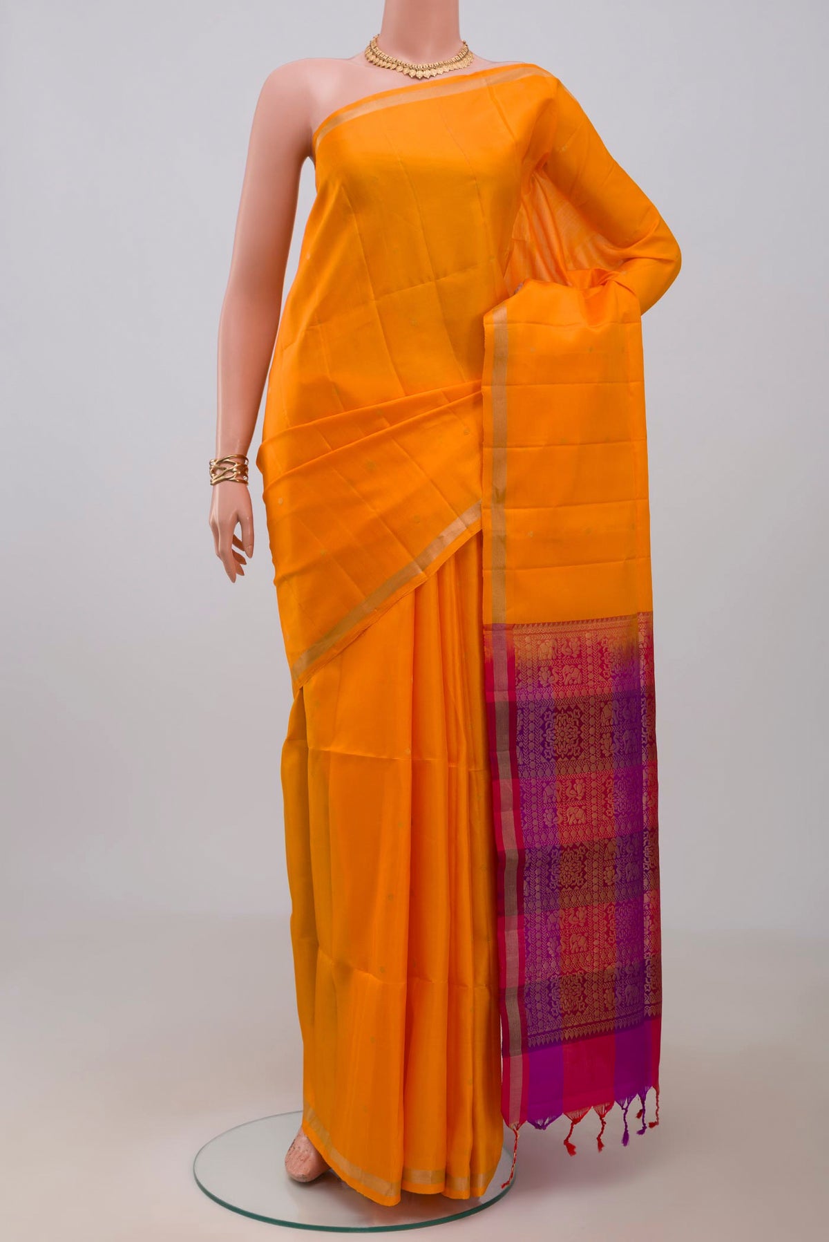 Yellow Soft Silk Saree with Zari Butta on the body and Thin Zari Line.  displayed on a mannequin