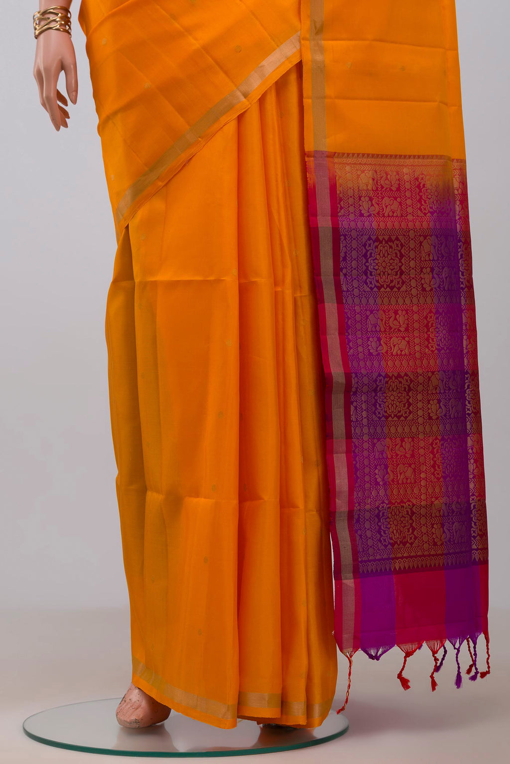 Pleats and pallu of Yellow Soft Silk Saree with Zari Butta on the body and Thin Zari Line. 