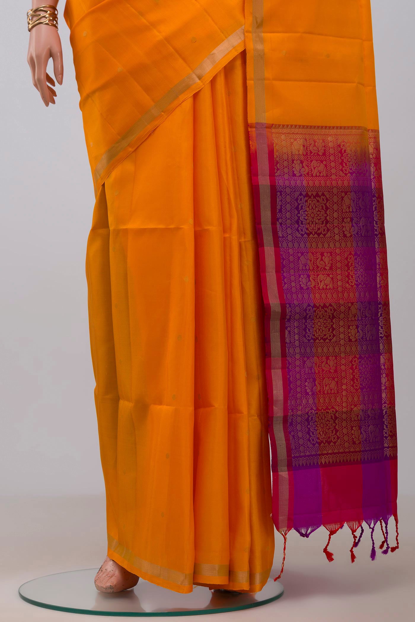 Pleats and pallu of Yellow Soft Silk Saree with Zari Butta on the body and Thin Zari Line. 