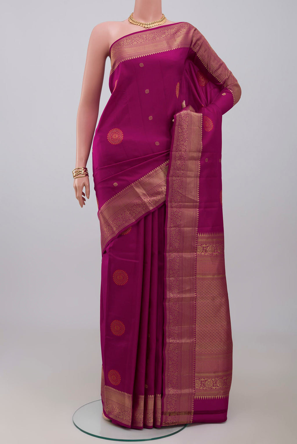 Purple Kanchipuram Saree with Zari Butta on the body and Zari Border.  displayed on a mannequin