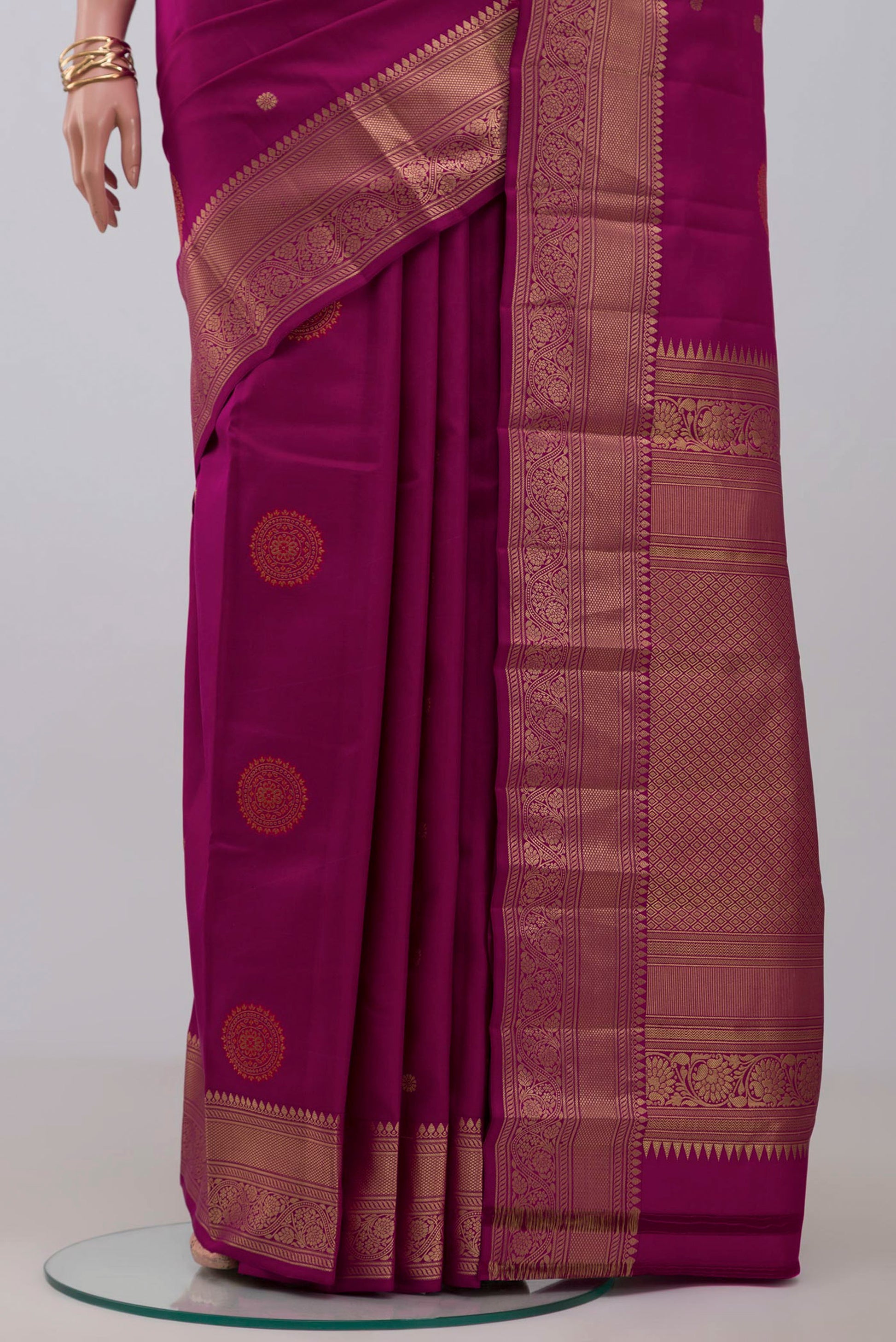 Pleats and pallu of Purple Kanchipuram Saree with Zari Butta on the body and Zari Border. 