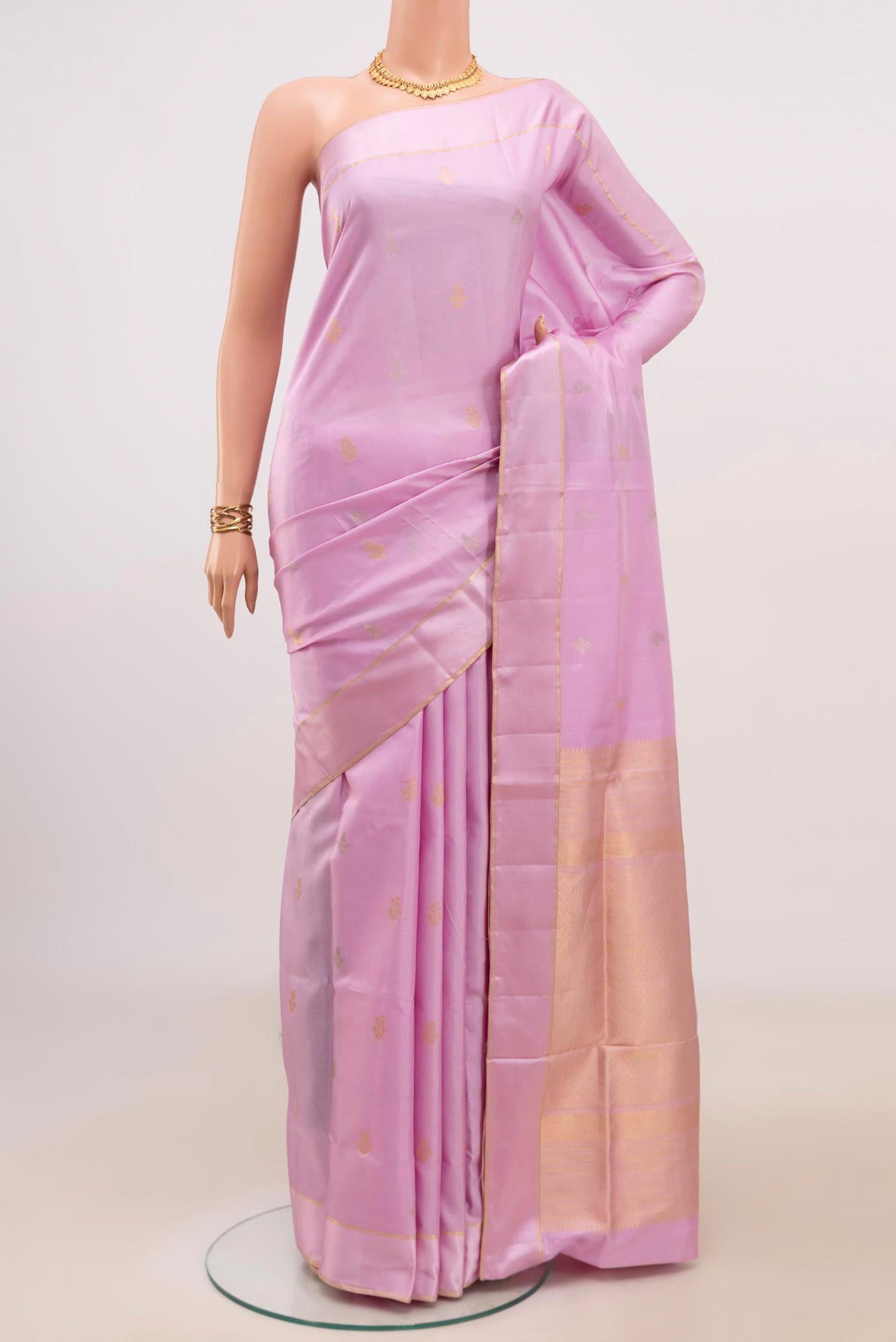 Lavender Soft Silk Saree with Zari Butta on the body and Thin Zari Line.  displayed on a mannequin