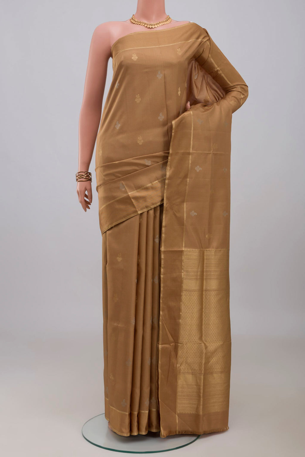 Beige Soft Silk Saree with Zari Butta on the body and Thin Zari Line.  displayed on a mannequin