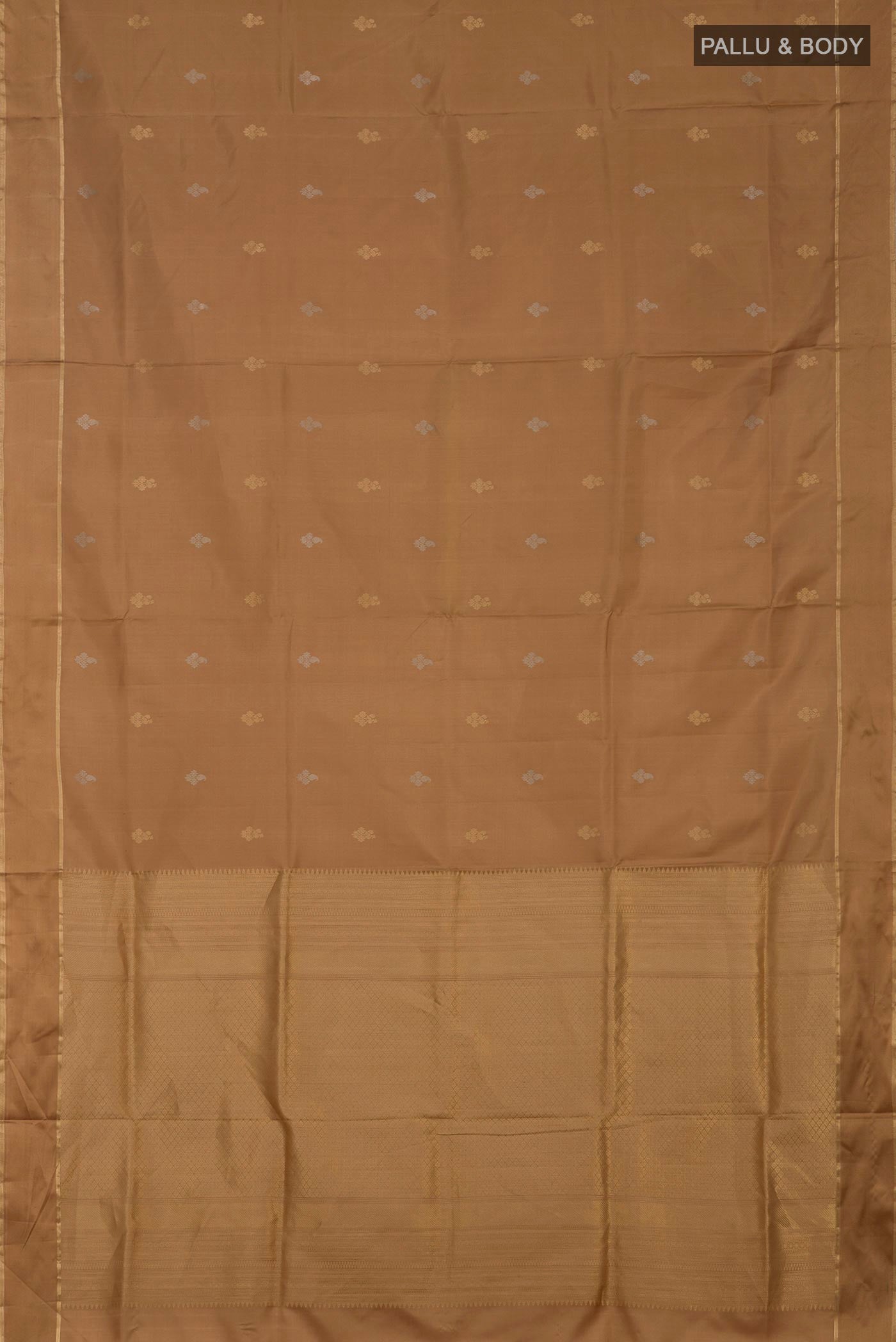 Flat view of Beige Soft Silk Saree with Zari Butta on the body and Thin Zari Line. 