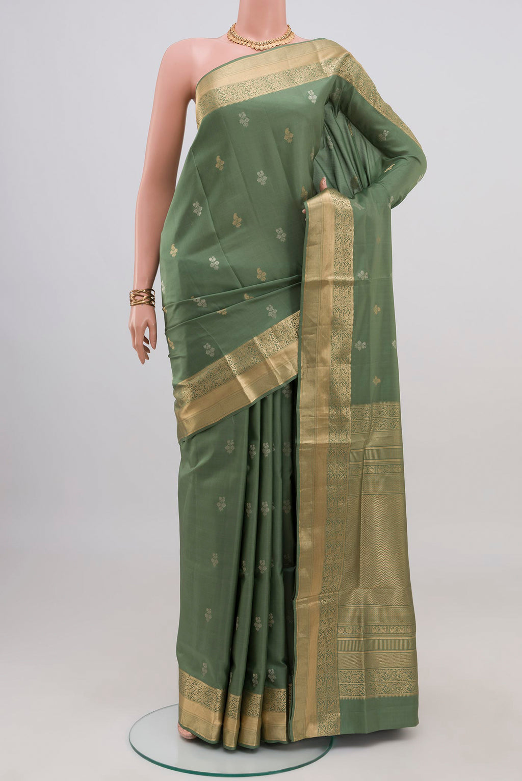Sage Green Soft Silk Saree with Zari Butta on the body and Zari Border.  displayed on a mannequin