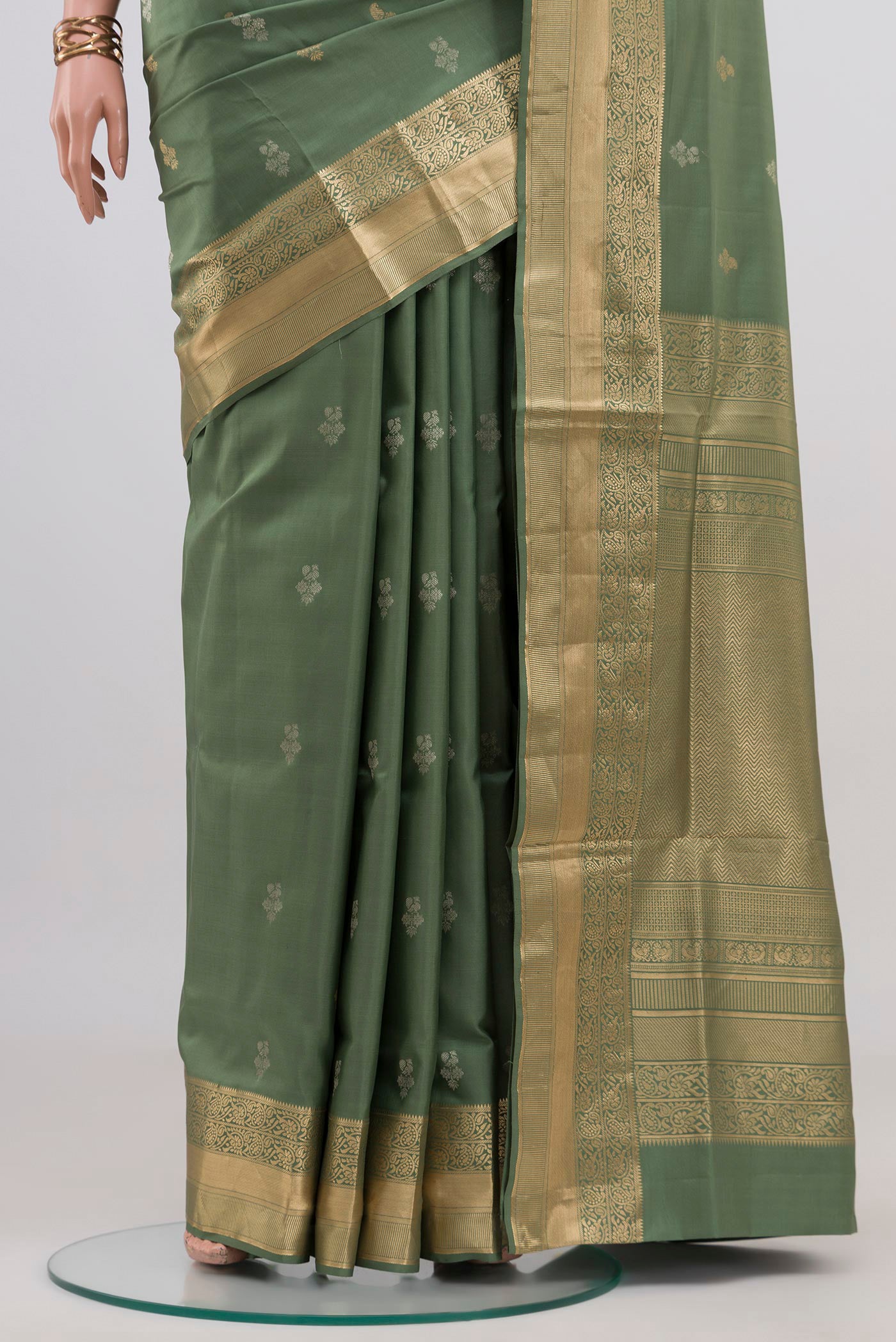 Pleats and pallu of Sage Green Soft Silk Saree with Zari Butta on the body and Zari Border. 