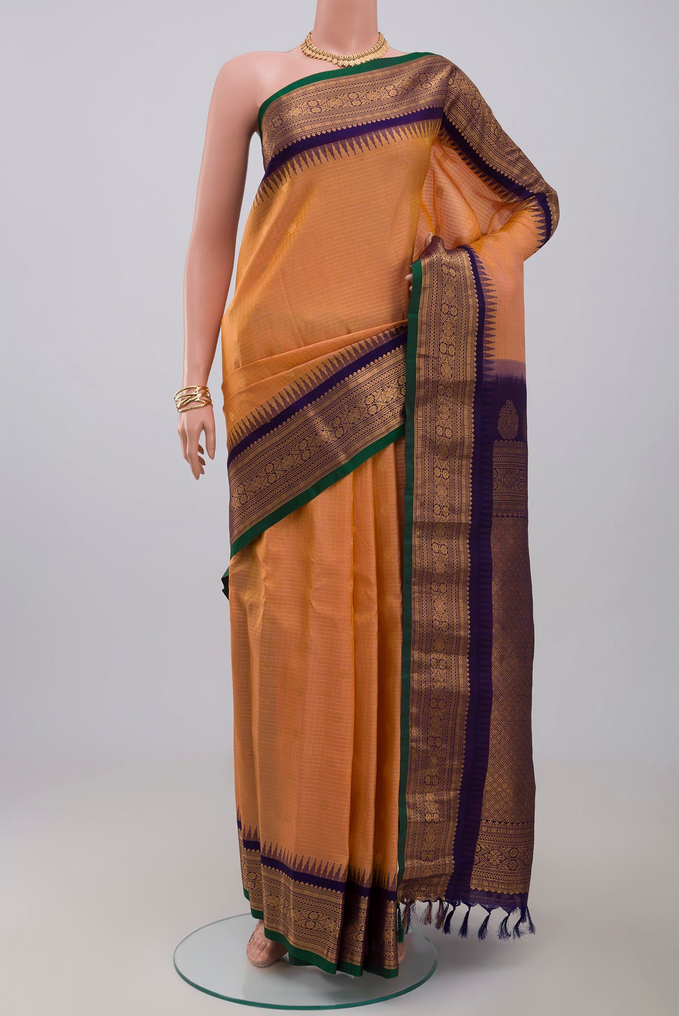 Peach Gadwal Silk Saree with Checked design on the body and Zari Border.  displayed on a mannequin