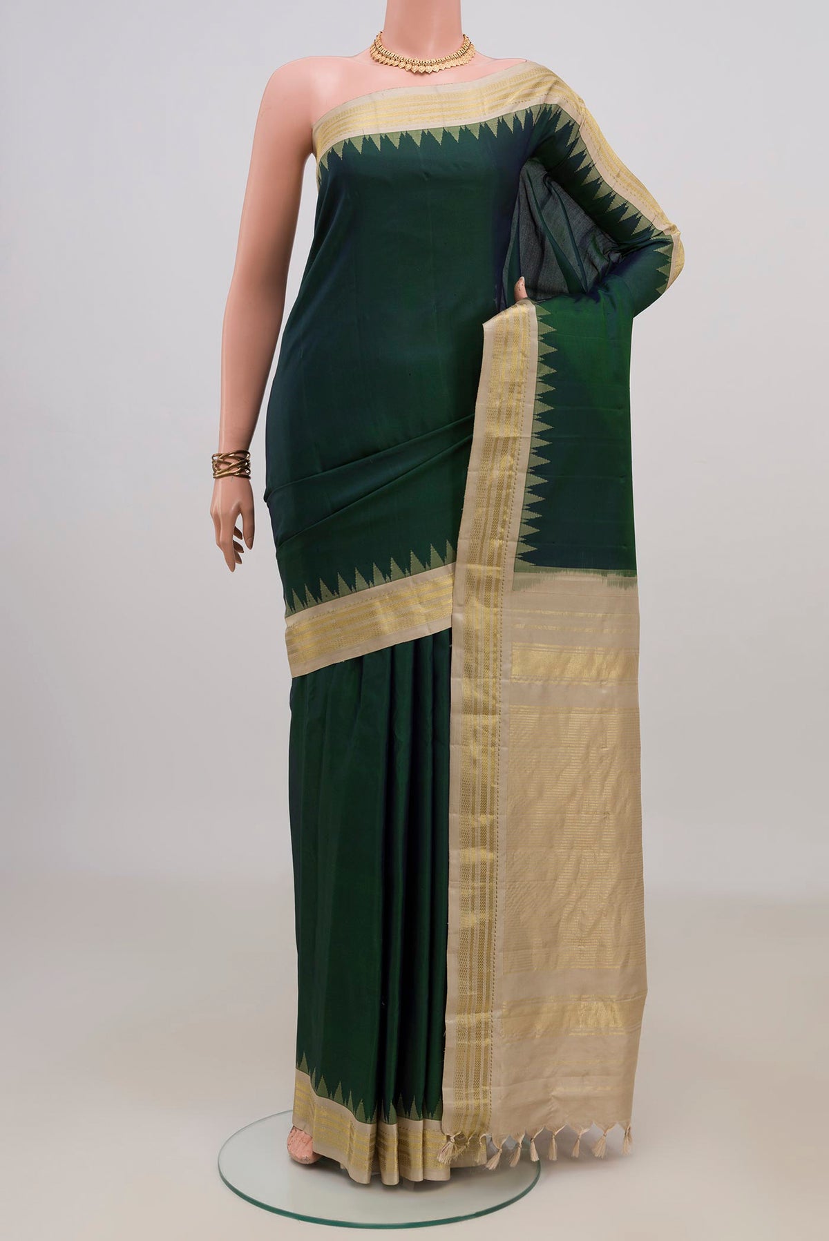 Pure Silk Bottle Green Gadwal Saree with Plain Body and Zari Border.  displayed on a mannequin