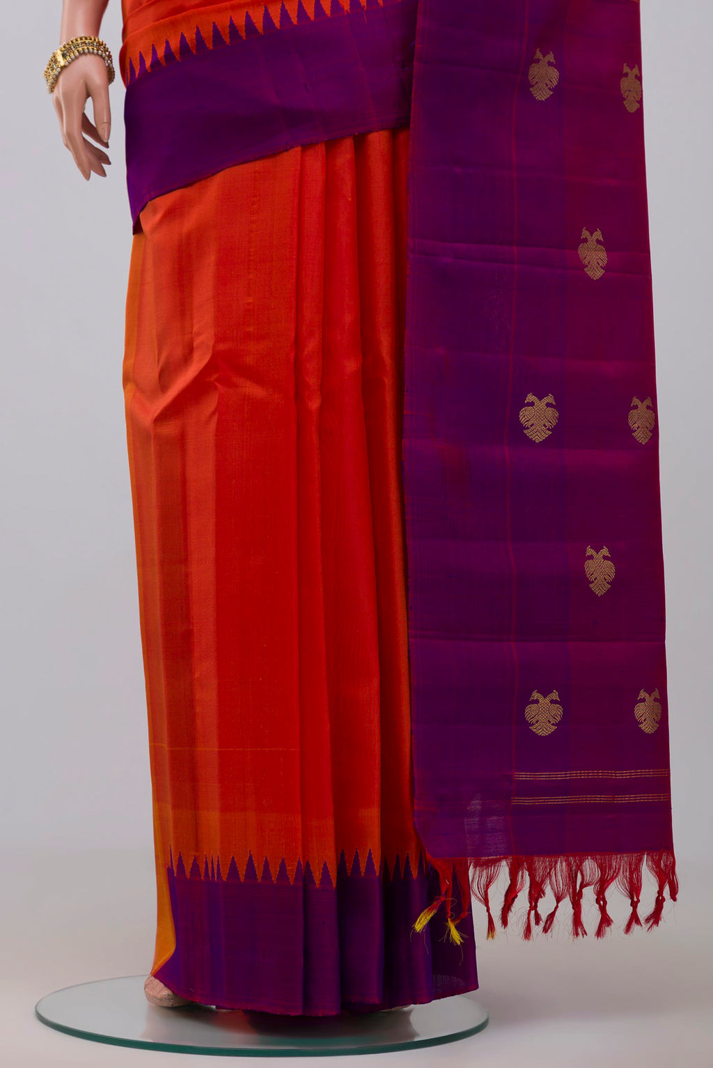 Pleats and pallu of Orange Gadwal Silk Saree with Plain Body and Temple Border. 