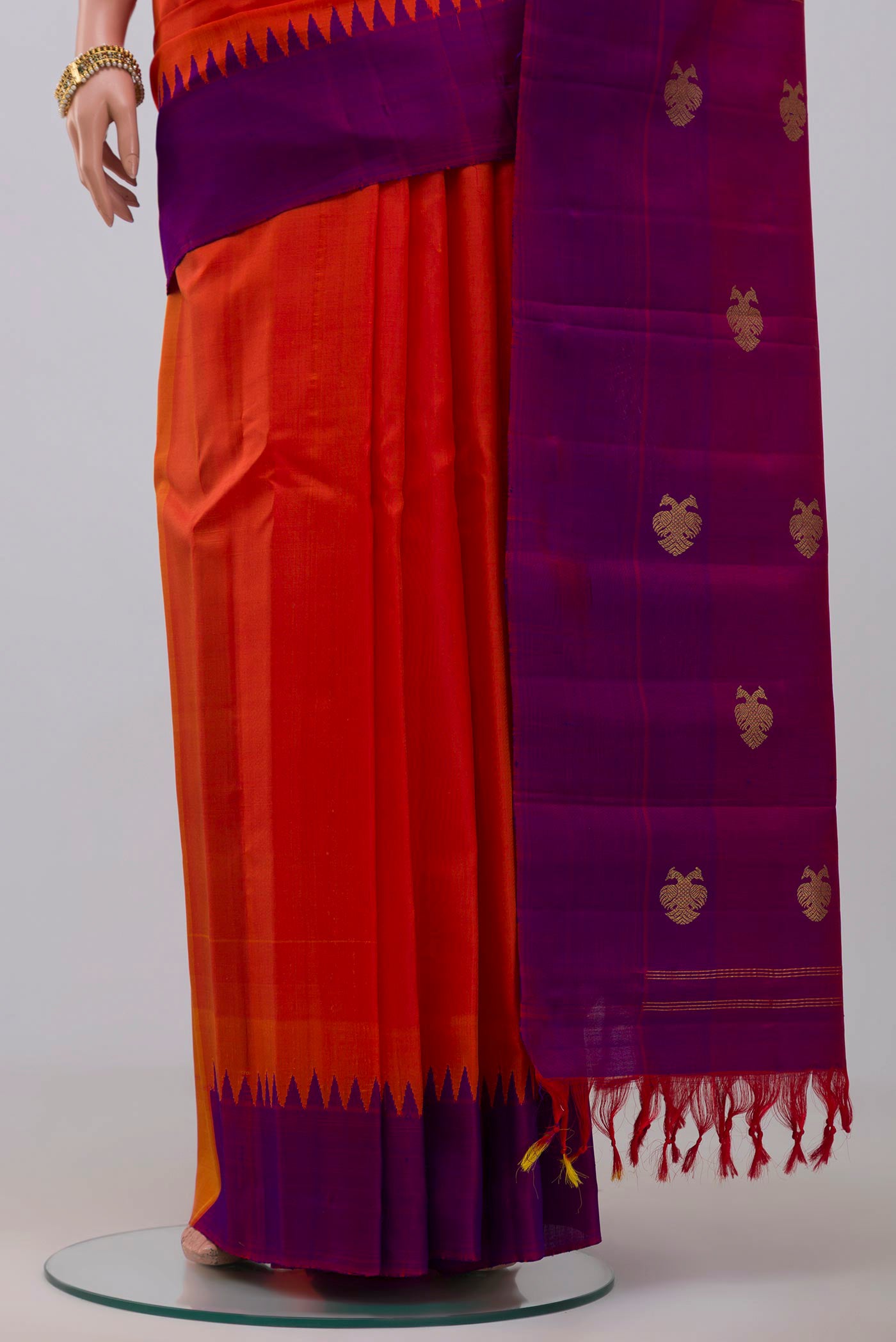 Pleats and pallu of Orange Gadwal Silk Saree with Plain Body and Temple Border. 