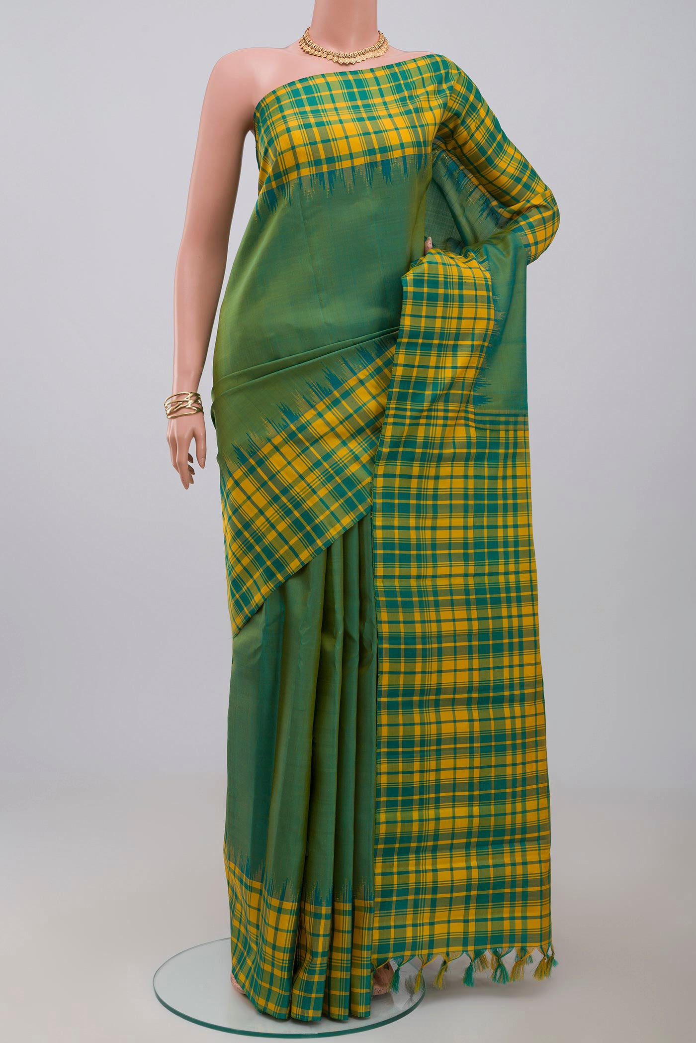 Green Gadwal Silk Saree with Plain Body and Checks Border.  displayed on a mannequin