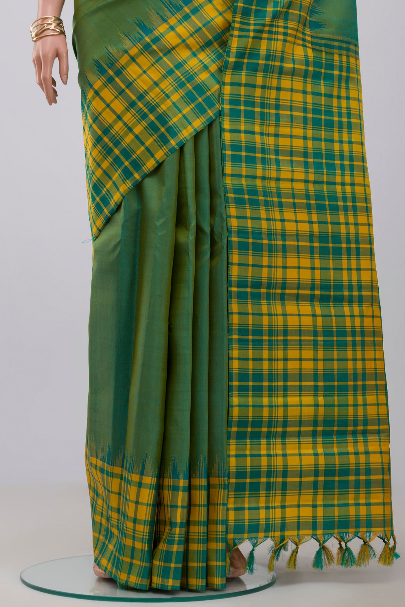 Pleats and pallu of Green Gadwal Silk Saree with Plain Body and Checks Border. 