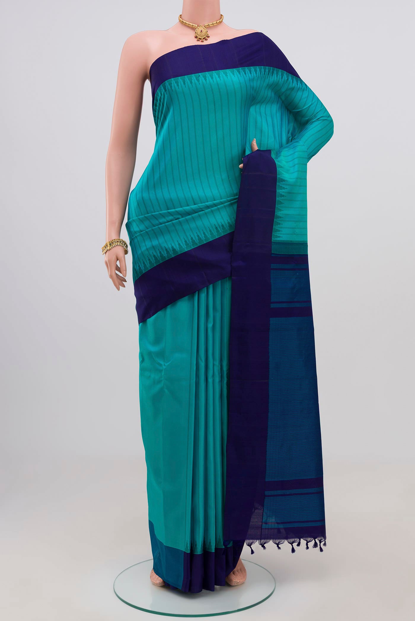 Sky Blue Gadwal Silk Saree with Stripes on the body and Plain Border.  displayed on a mannequin