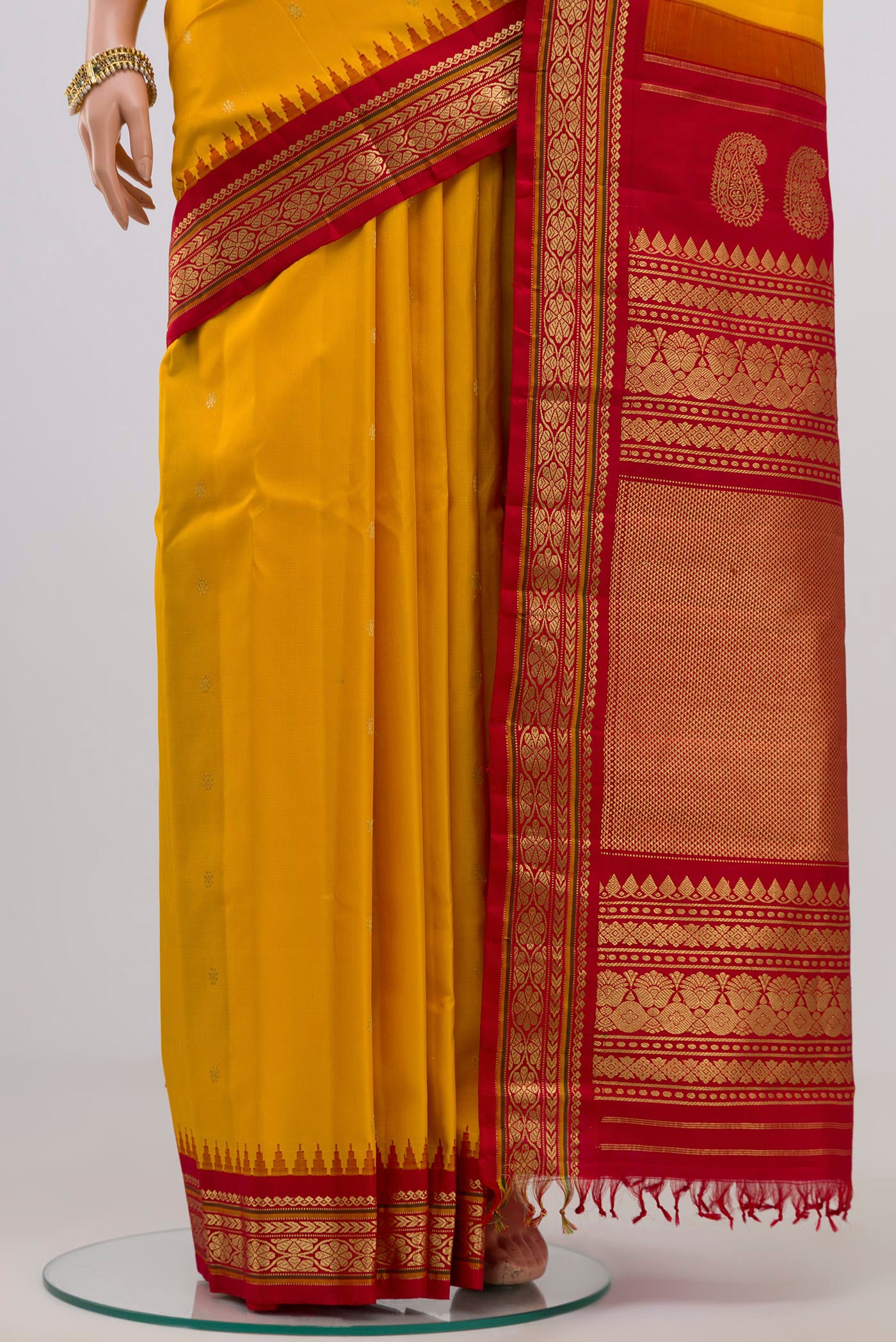 Pleats and pallu of Yellow Gadwal Silk Saree with Zari Butta on the body and Zari Border. 
