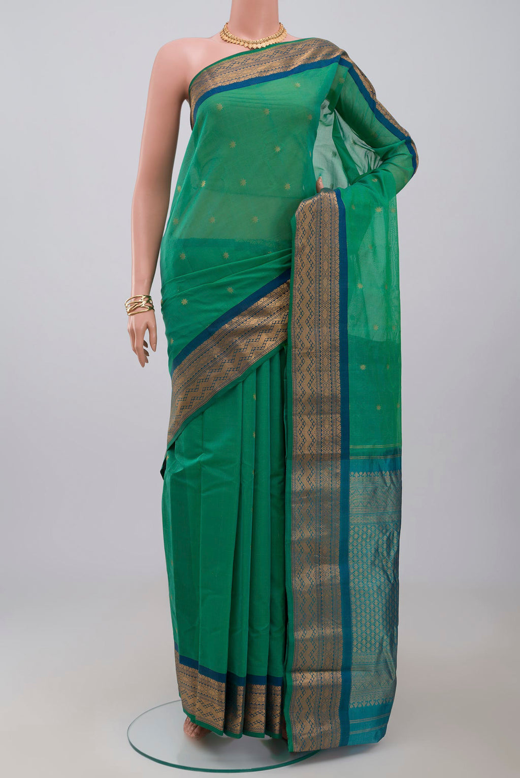Green Gadwal Silk Cotton Saree with Zari Butta on the body and Zari Border.  displayed on a mannequin