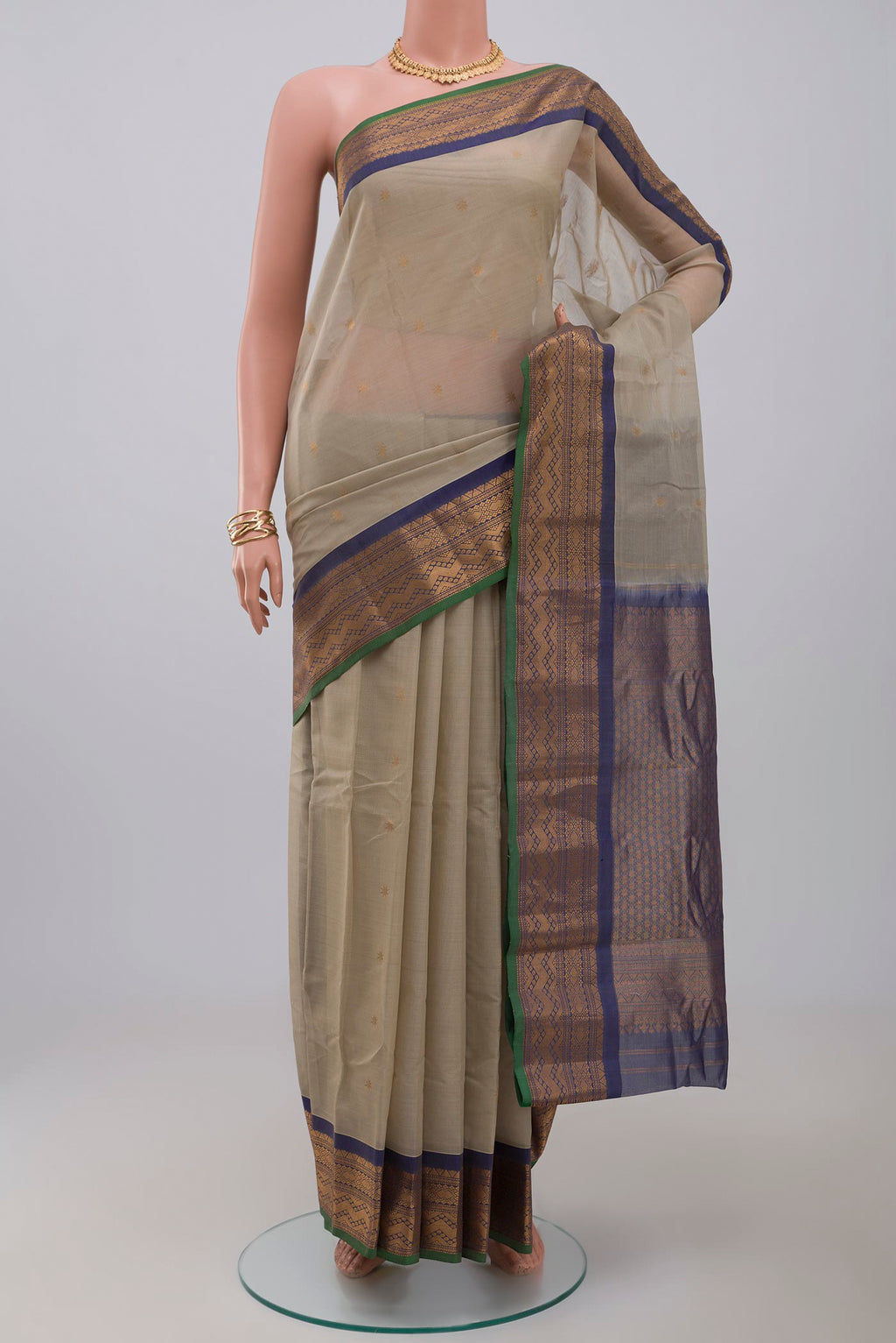 Cream Gadwal Silk Cotton Saree with Zari Butta on the body and Zari Border.  displayed on a mannequin