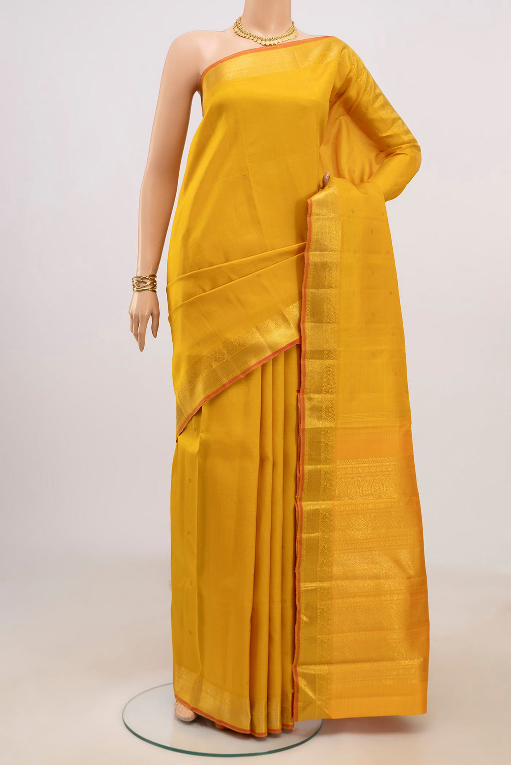 Pure Silk Pure Zari Yellow Kanjivaram Saree with Zari Butta on the body and Zari Border.  displayed on a mannequin