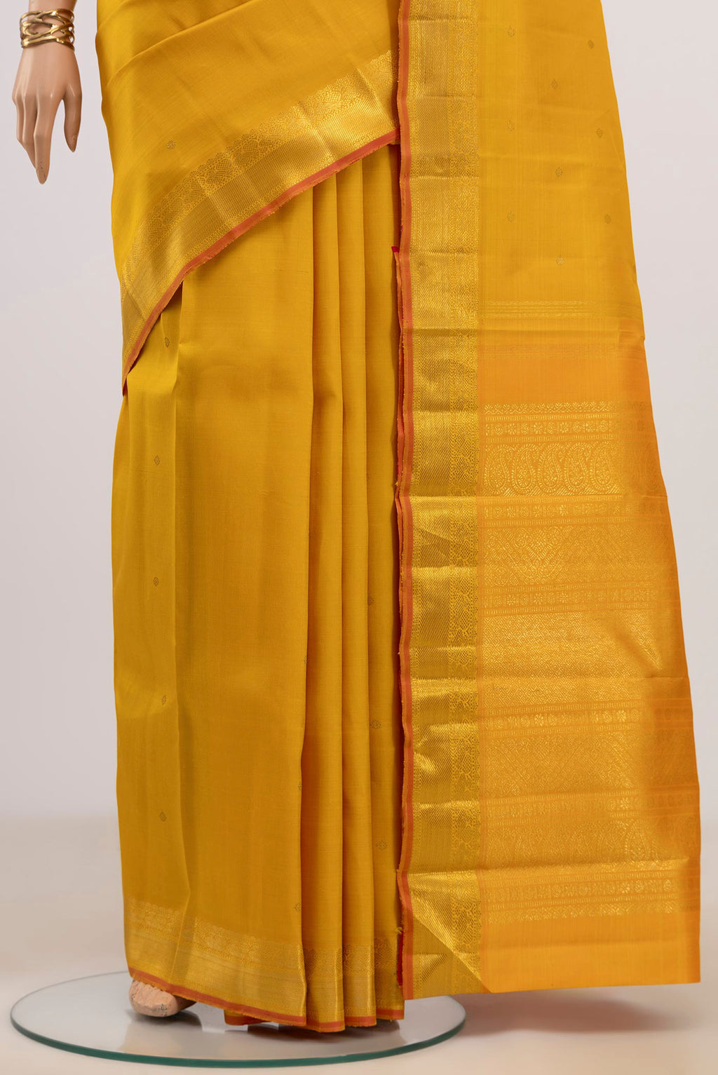 Pleats and pallu of Pure Silk Pure Zari Yellow Kanjivaram Saree with Zari Butta on the body and Zari Border. 