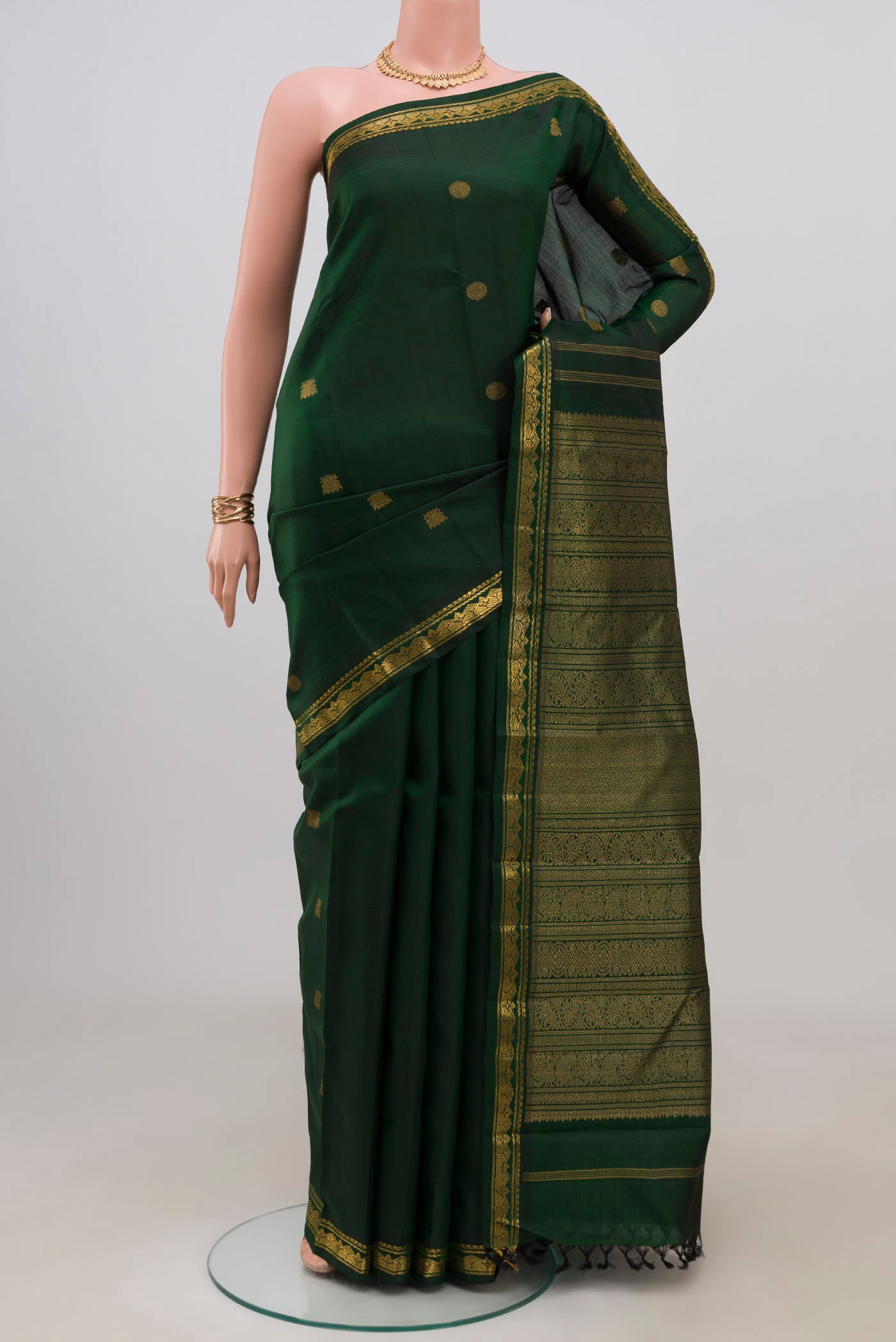 Pure Silk Pure Zari Green Kanchipuram Saree with Zari Butta on the body and Zari Border.  displayed on a mannequin